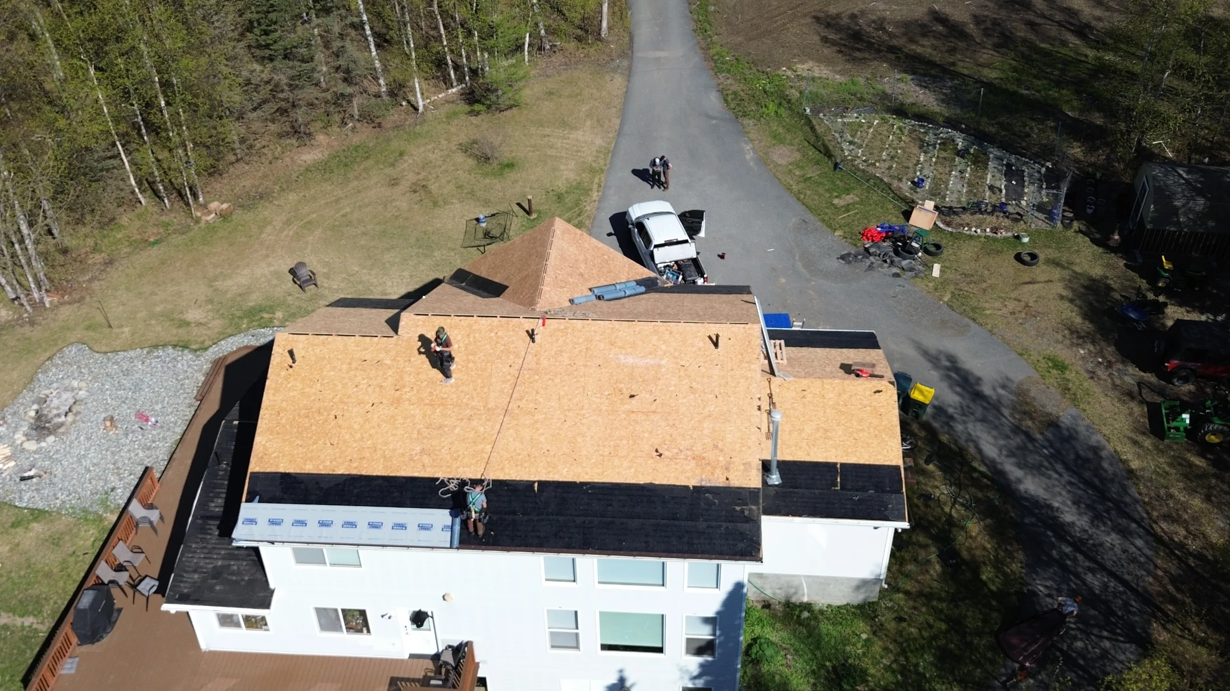 A modern single-family home with a partially installed metal roof