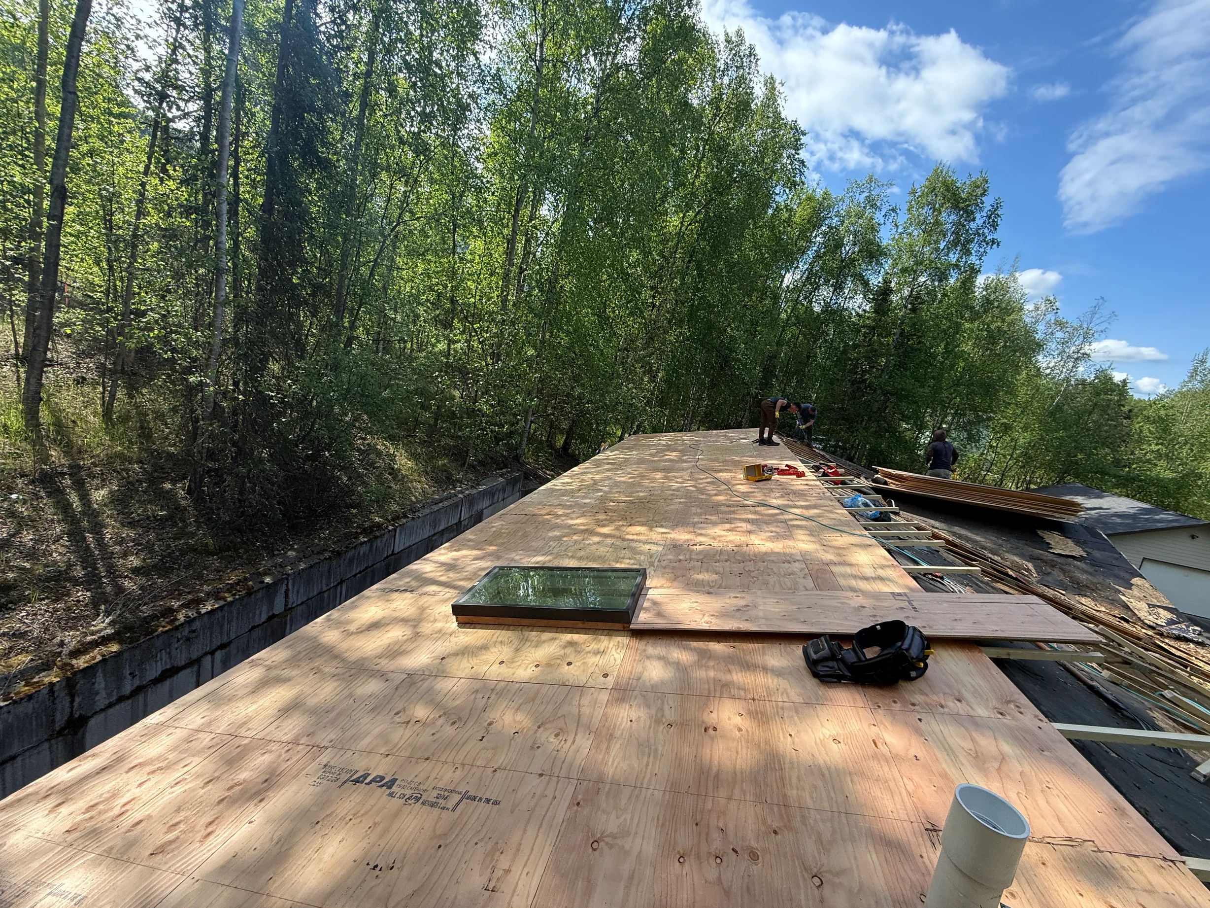 Black Interlock Shake aluminum roof being installed on the home, replacing a rotten asphalt shingle roof, Chugiak, Alaska
