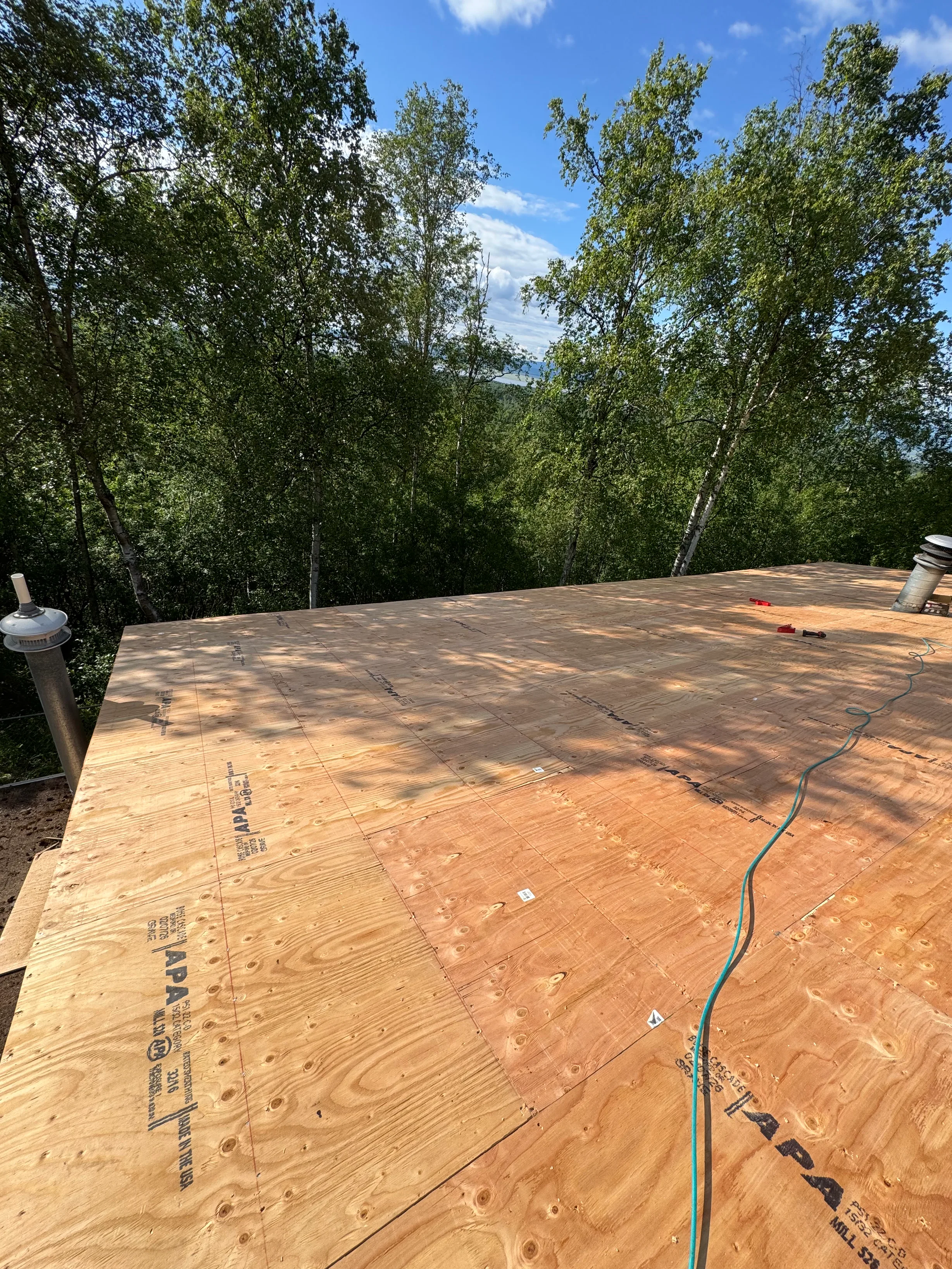 Tile Red Interlock Cedar Shingle aluminum roof being installed on the home, replacing a rotten asphalt shingle roof, Chugiak, Alaska