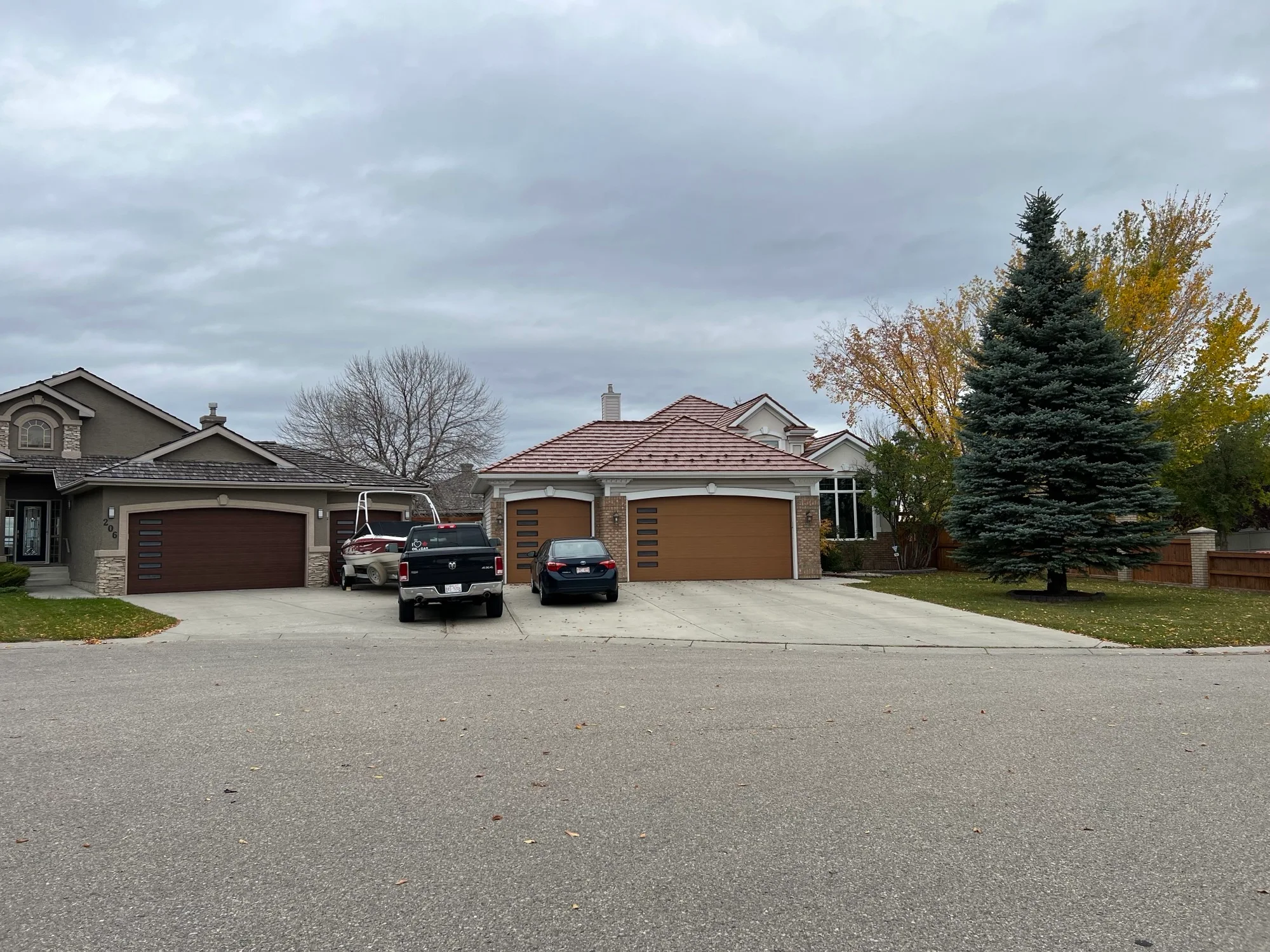 Aged Copper Interlock Shake aluminum roof on a beige one-storey home with a metal roof and attached, Calgary, Alberta