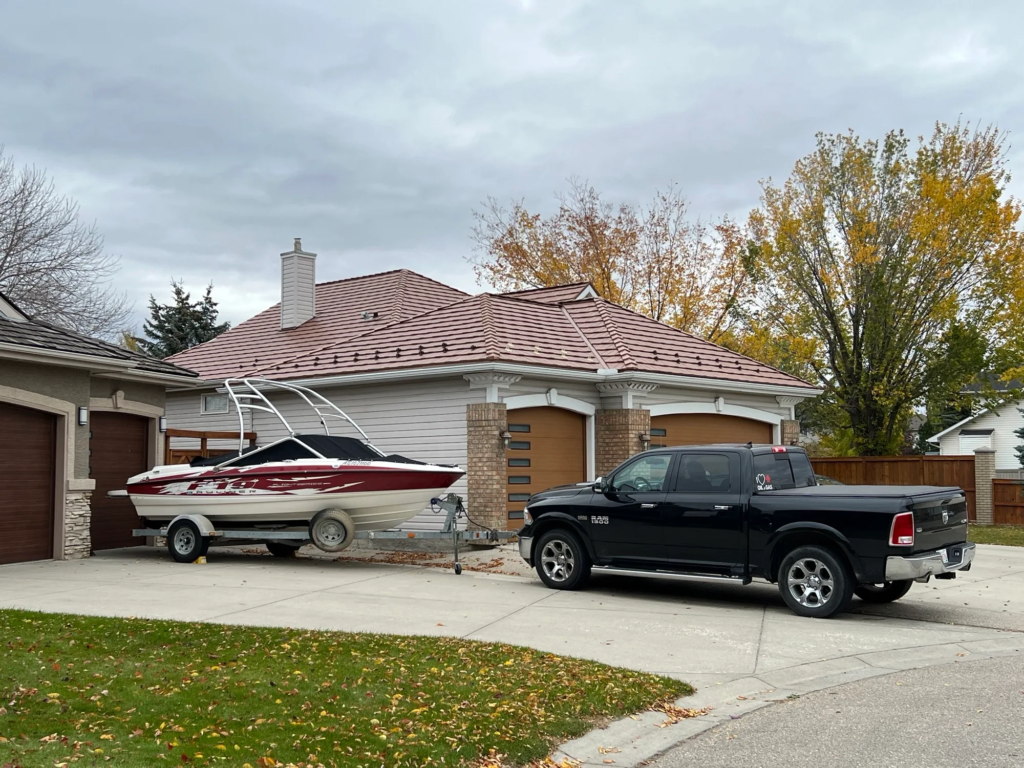 Aged Copper Interlock Shake aluminum roof on a two-storey home with a metal roof and solar panels among, Calgary, Alberta