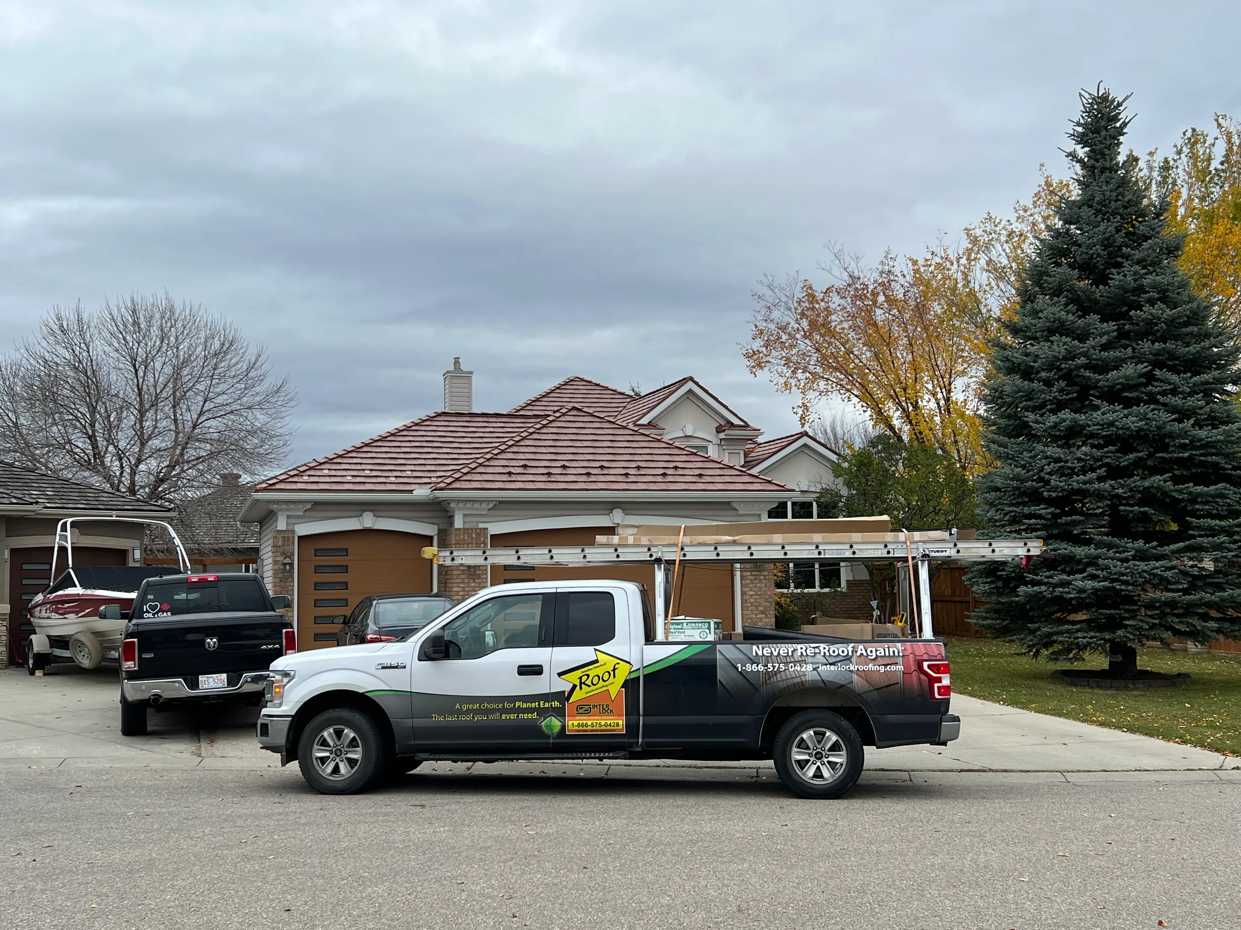 Aged Copper Interlock Shake aluminum roof on a house with a brown brick exterior and a red tile roof in, Calgary, Alberta