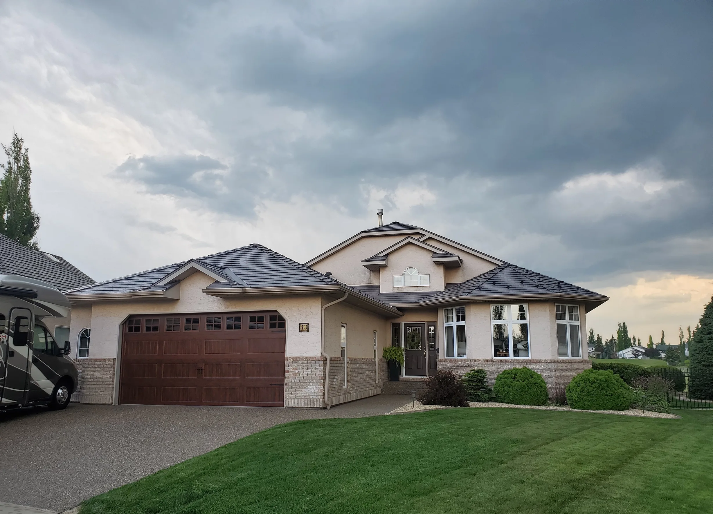 Weathered Interlock Slate aluminum roof on a tan ranch style home with a metal roof in a rural area, Red Deer, Alberta