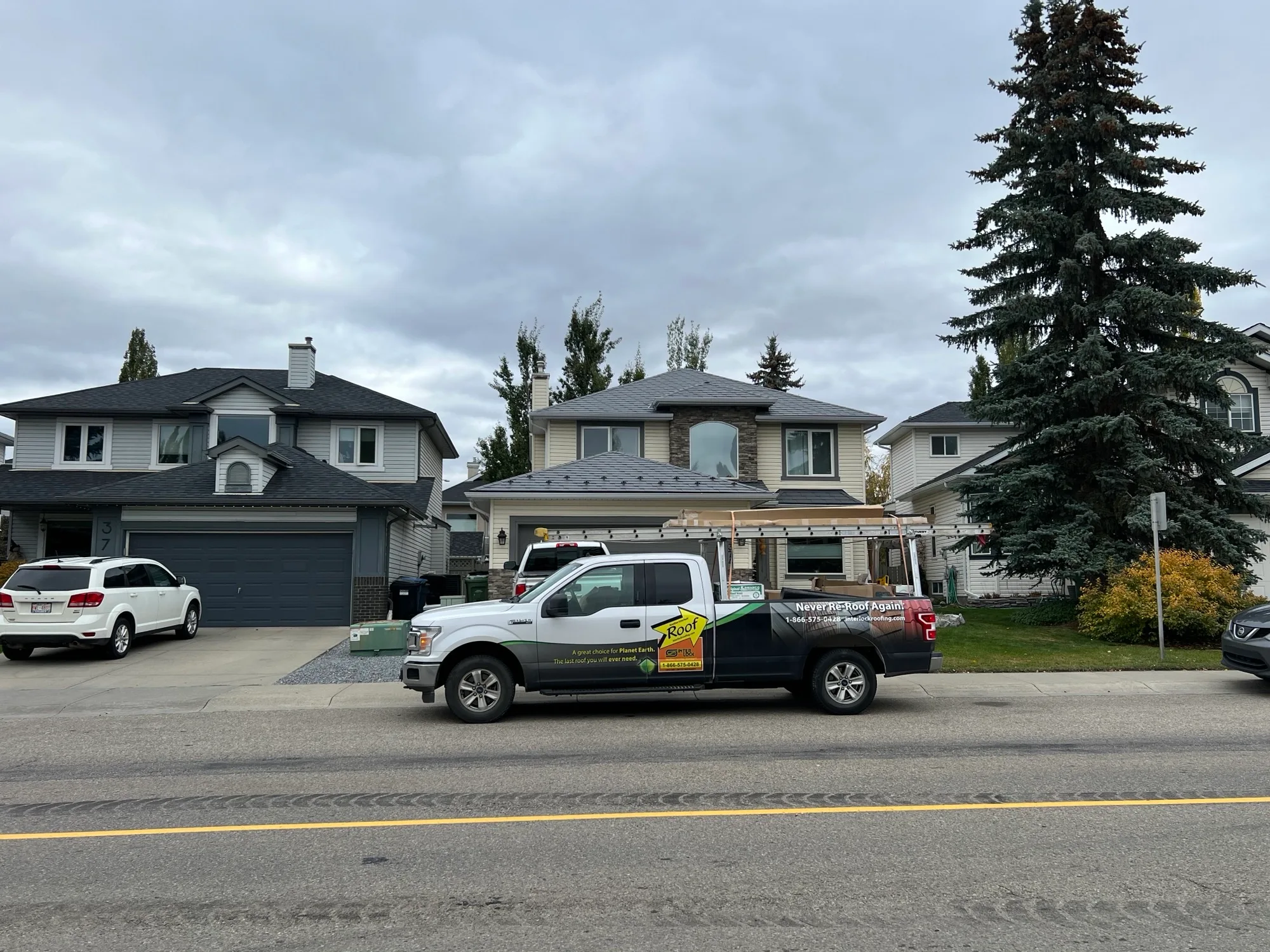Charcoal Grey Interlock Slate aluminum roof on a two-storey home with a metal roof in a suburban, Calgary, Alberta