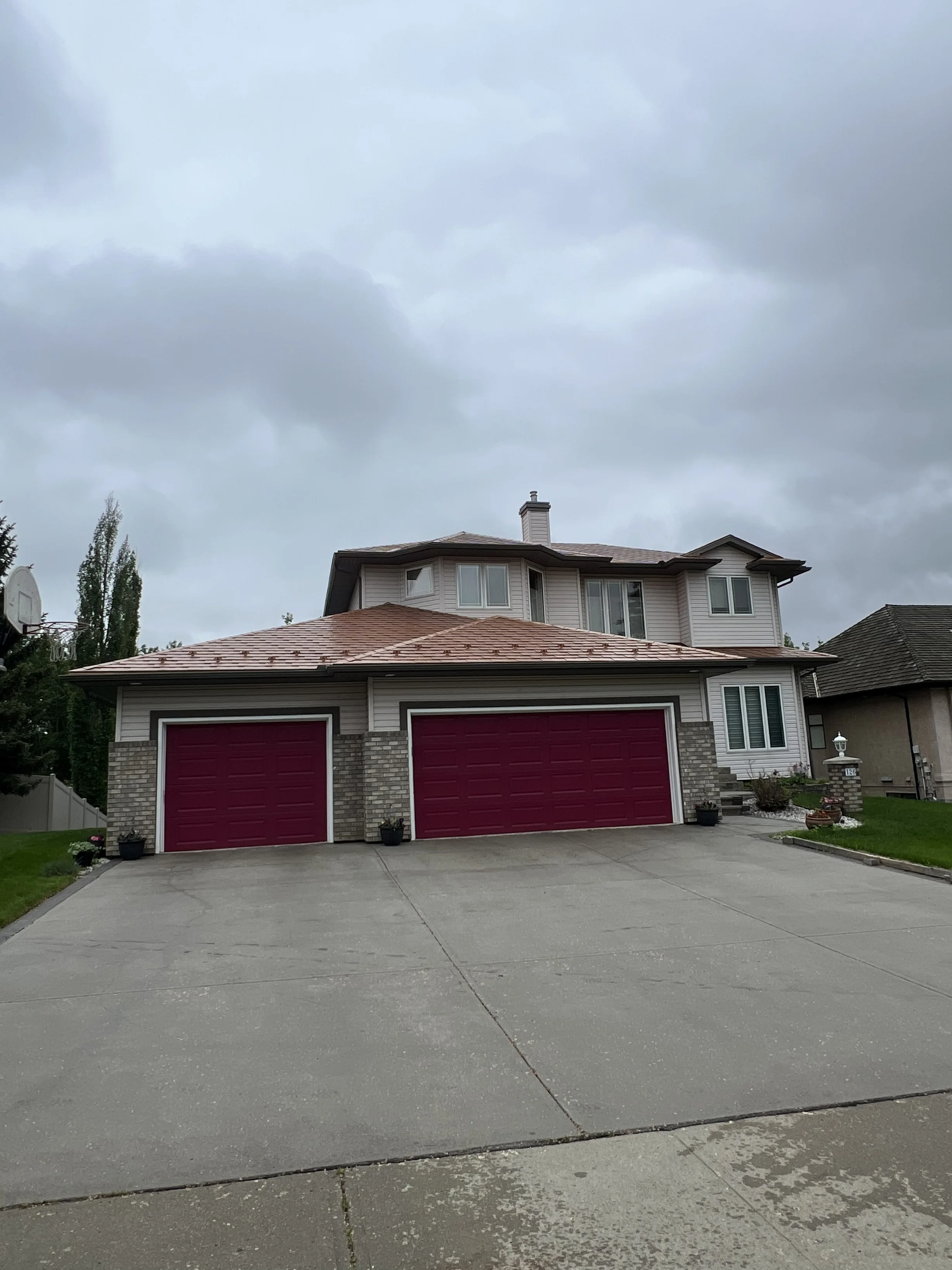 Aged Copper Interlock Slate aluminum roof on a beige two-storey home with dormers in a suburban, Sherwood Park, Alberta