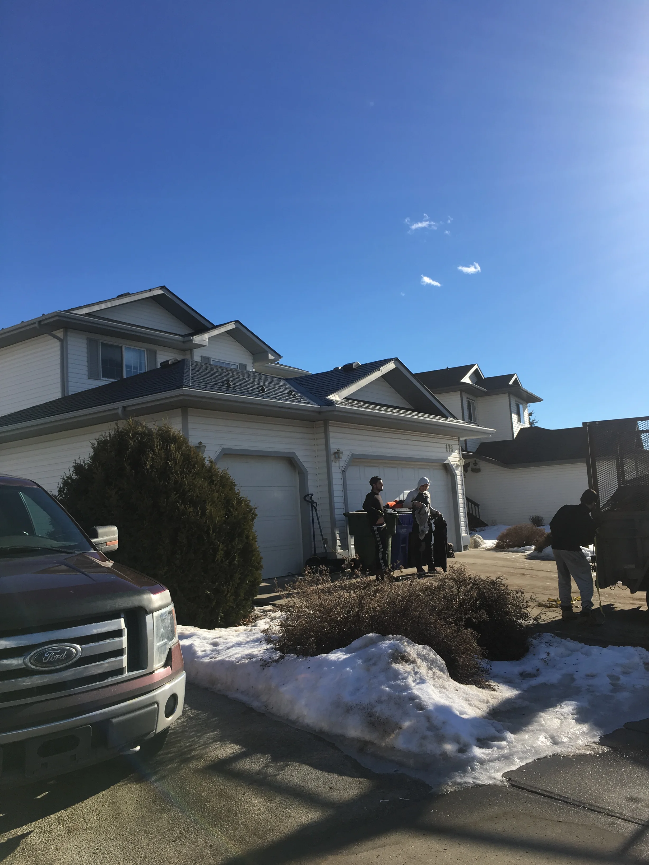 Deep Charcoal Interlock Slate aluminum roof on a white single-family home with a modern roof among snow, Fort Saskatchewan, Alberta
