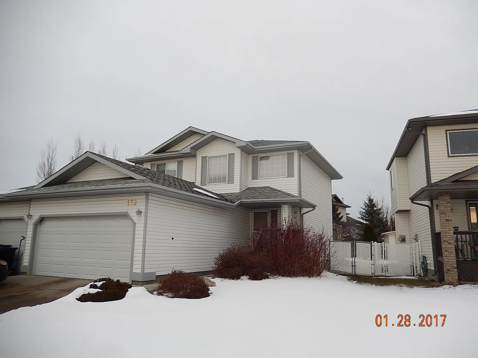 Deep Charcoal Interlock Slate aluminum roof on a white modern home with snow in a rural setting, Fort Saskatchewan, Alberta