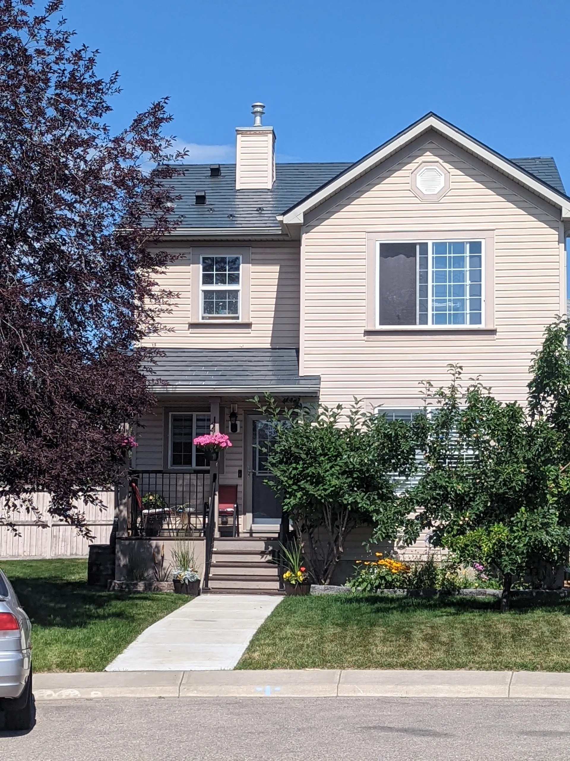 Deep Charcoal Interlock Slate aluminum roof on a two-storey colonial home with a chimney among urban, Calgary, Alberta