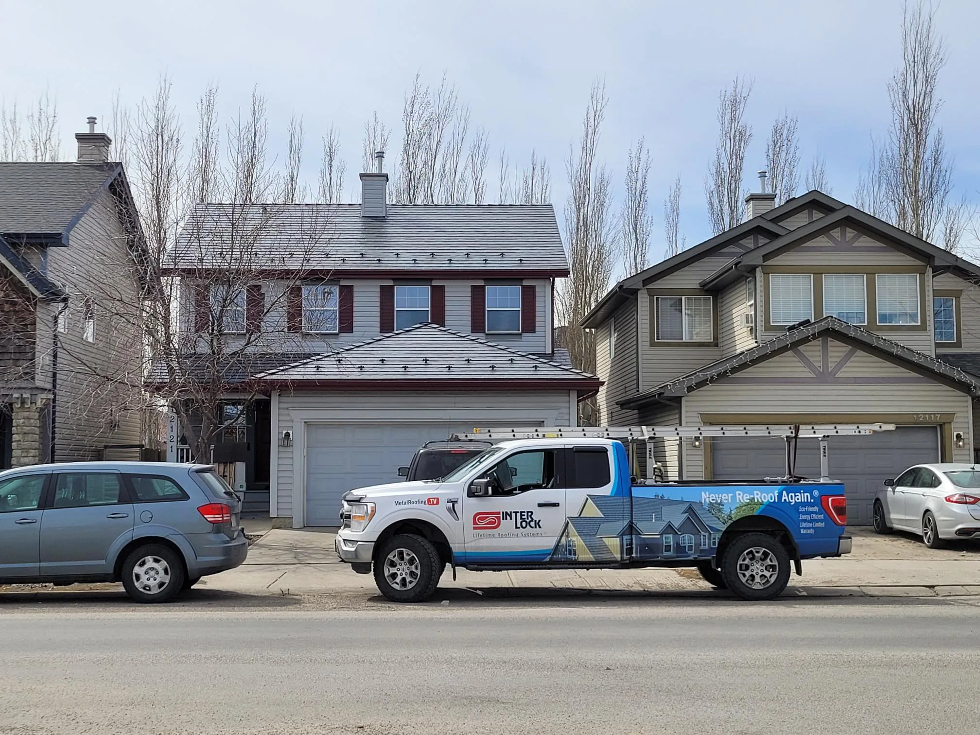 Deep Charcoal Interlock Slate aluminum roof on a two-storey modern home with dormers in a mountainous, Calgary, Alberta