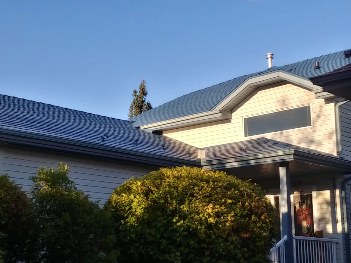 Royal Blue Interlock Slate aluminum roof on a Royal Blue Interlock Slate metal roof on a white home in, Devon, Alberta