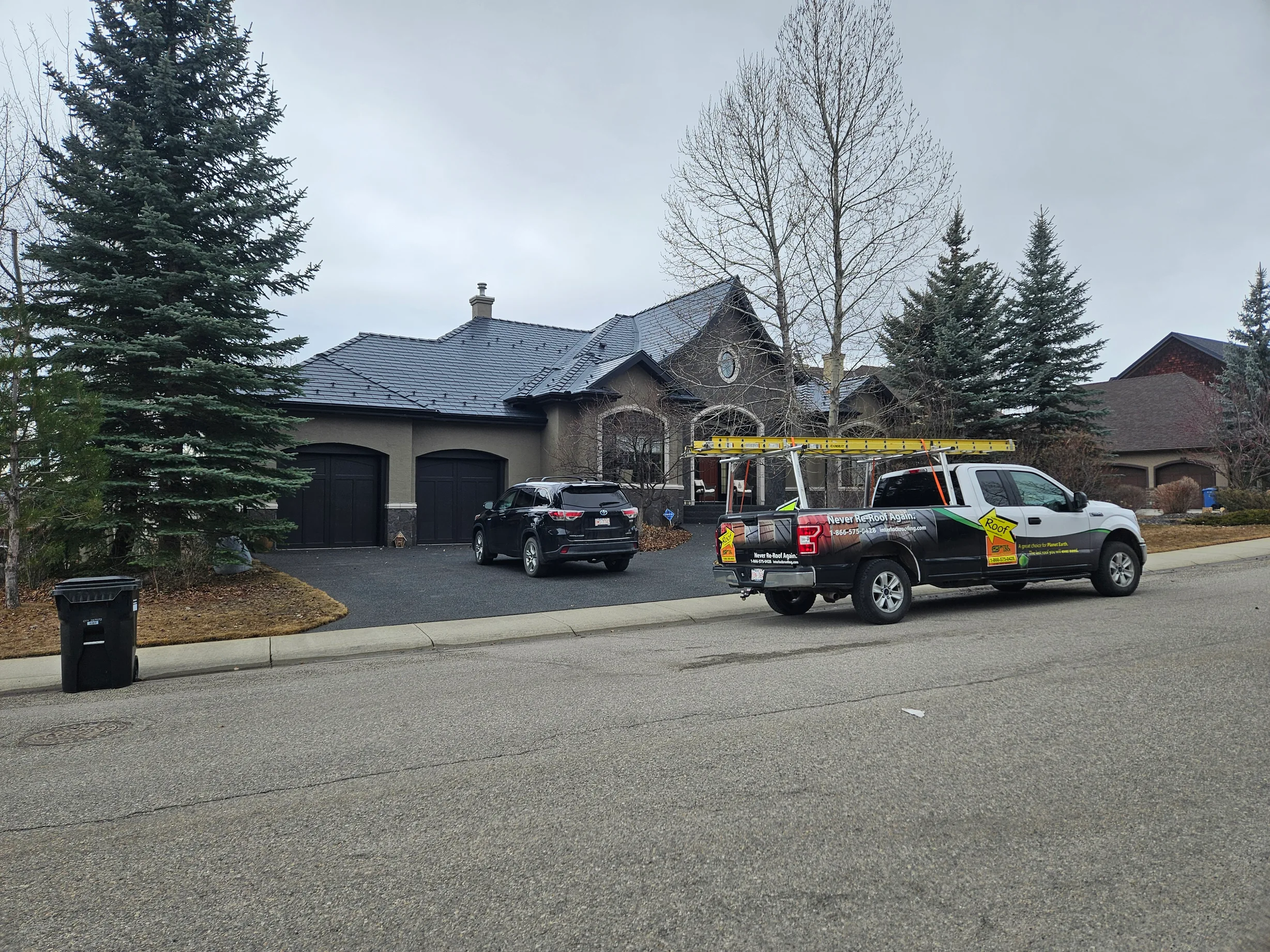 Deep Charcoal Interlock Slate aluminum roof on a two-storey home with a metal roof in a residential area, Calgary, Alberta