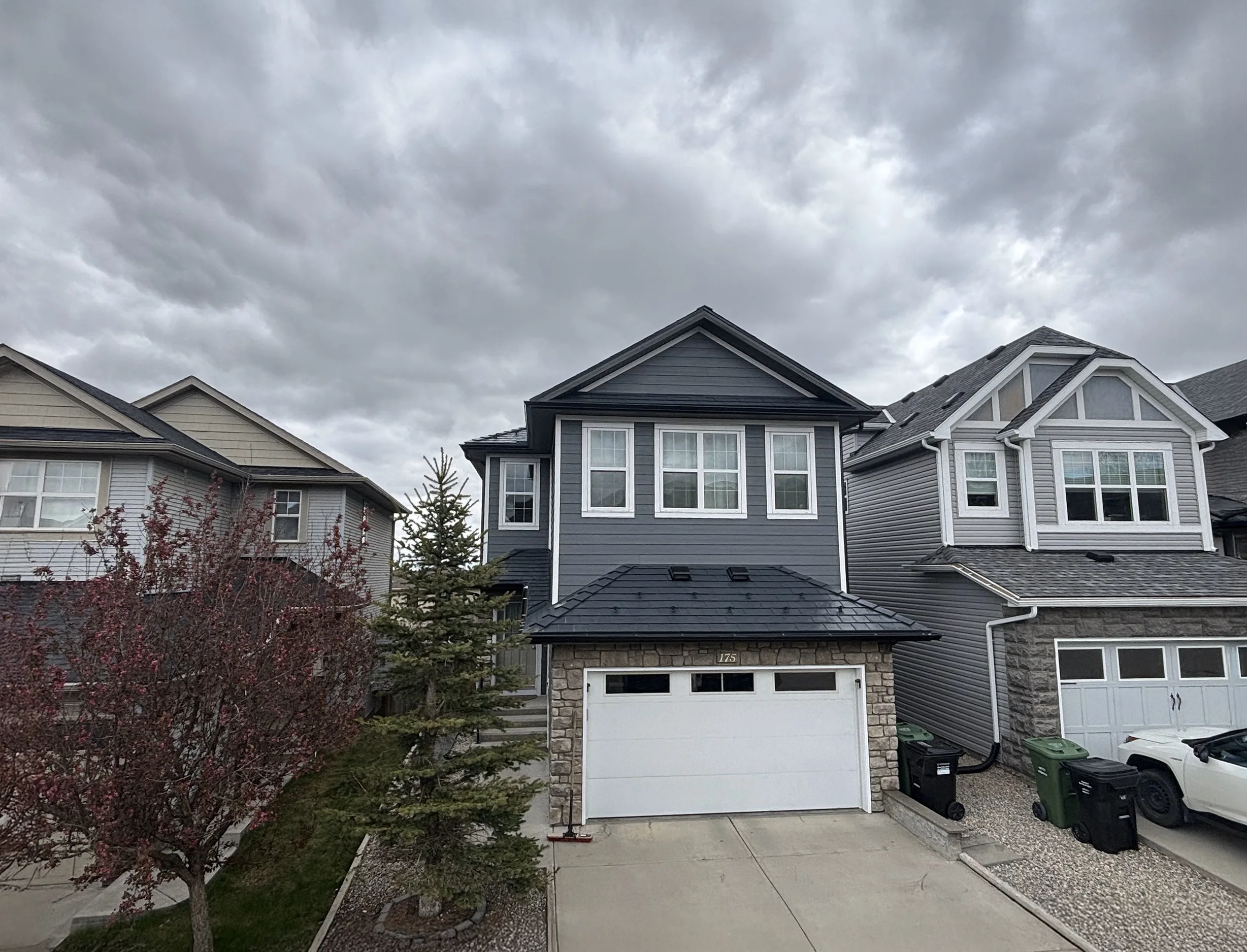 Deep Charcoal Interlock Slate aluminum roof on a two-storey home with dormers in a residential, Calgary, Alberta