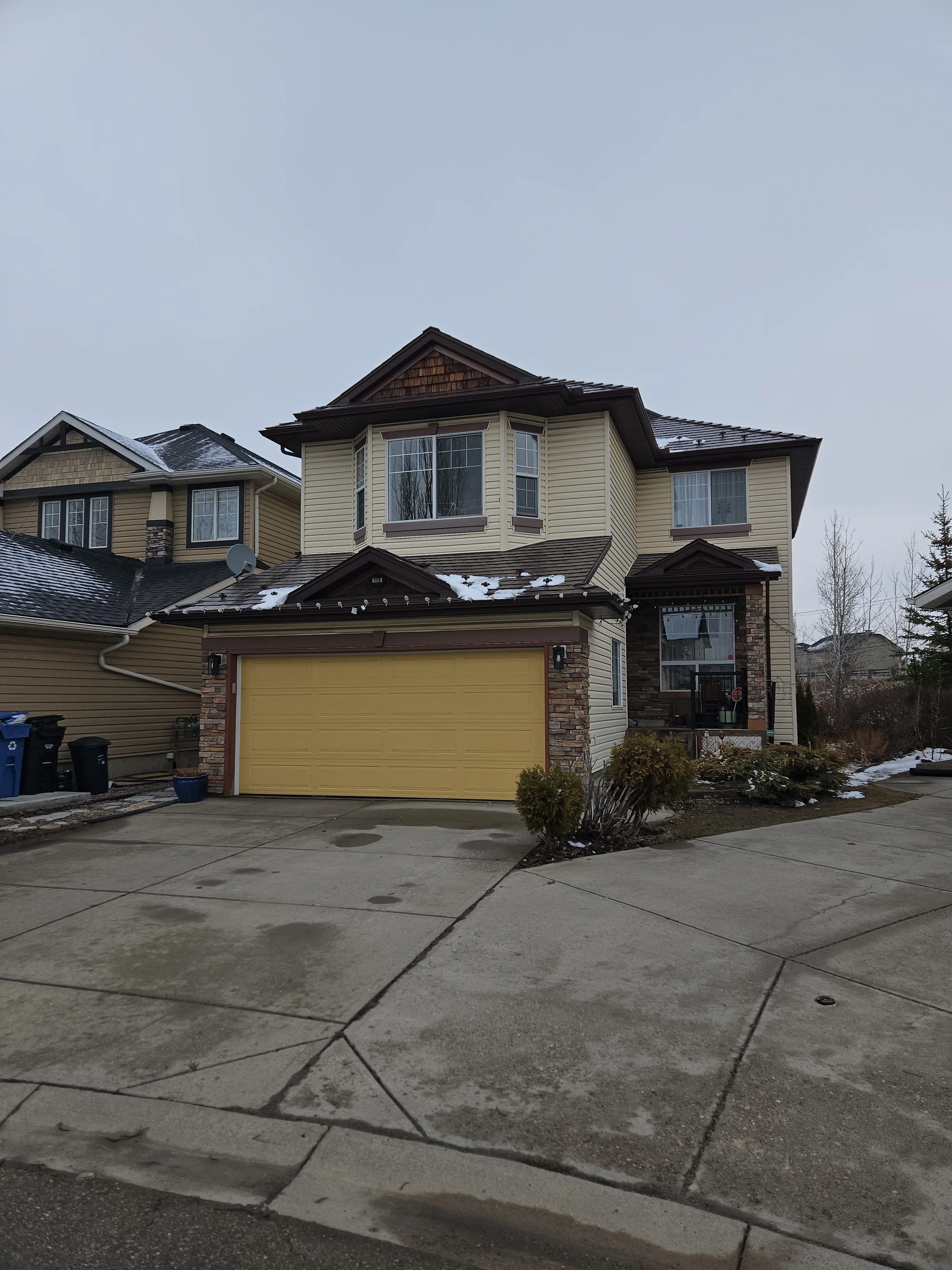 Colonial Brown Interlock Slate aluminum roof on a Colonial brown two-storey home with a brown roof among, Calgary, Alberta