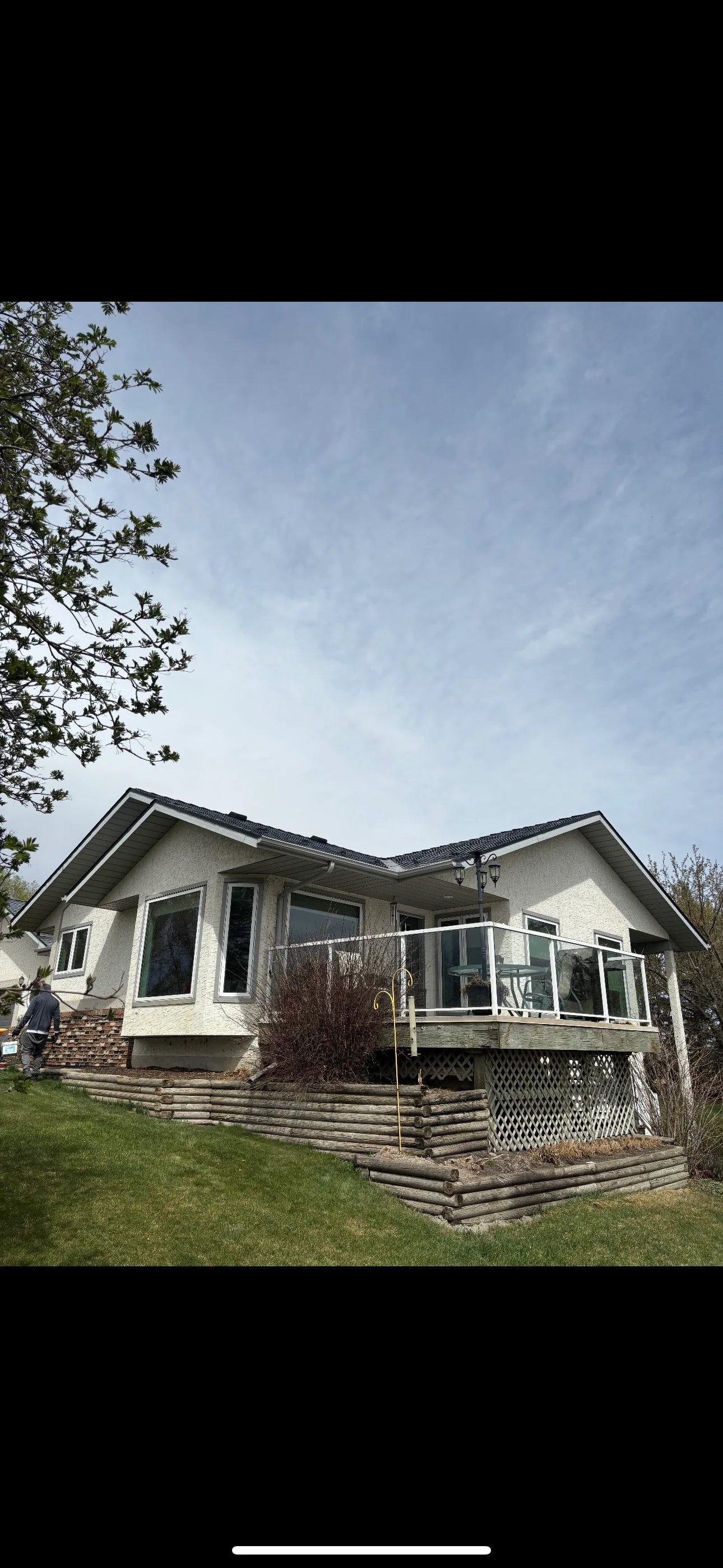 Deep Charcoal Interlock Slate aluminum roof on a white ranch home with a metal roof in a rural setting, Red Deer County, Alberta