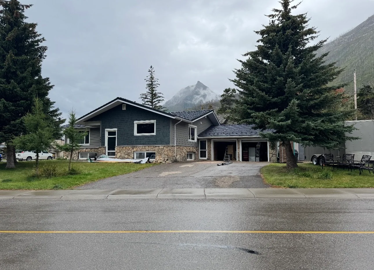 Black Interlock Shake aluminum roof on a two-storey chalet with a metal roof in the mountains, Waterton Park, Alberta