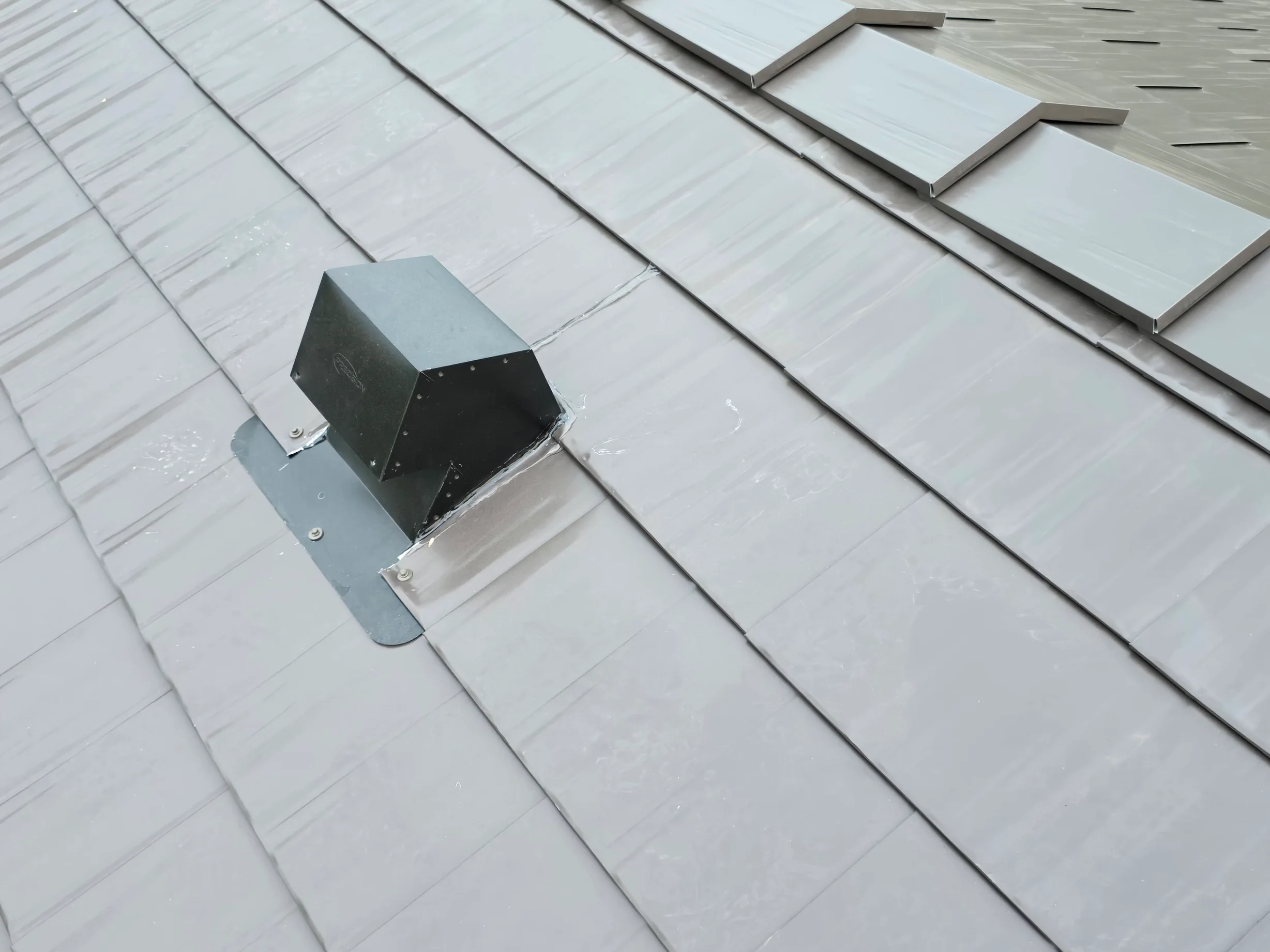 Tudor Brown Interlock Cedar Shingle aluminum roof on a Tudor-style home with a metal roof in the mountains, Rocky Mountain House, Alberta
