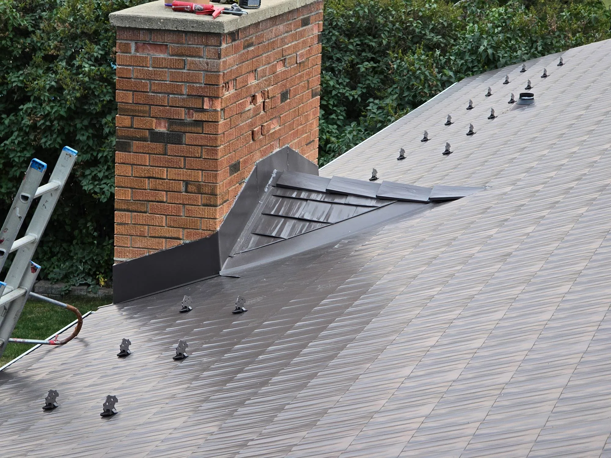 Interlock Aluminum Cedar Shingle Metal Roofing – Tudor Brown | Rocky Mountain House, AB (Chimney flashing detail)