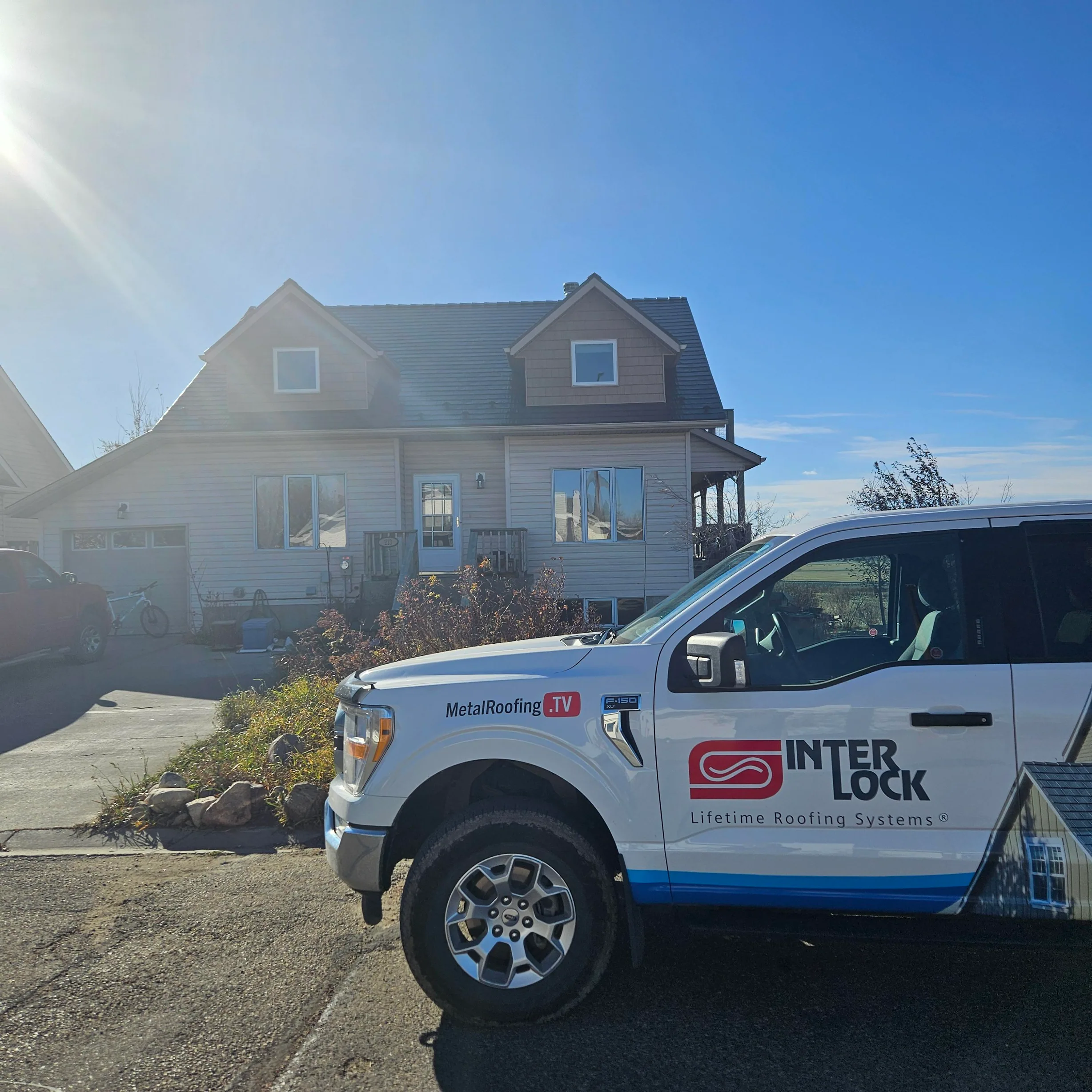 Colonial Brown Interlock Cedar Shingle aluminum roof on a colonial home with dormers in a rural setting, Three Hills, Alberta