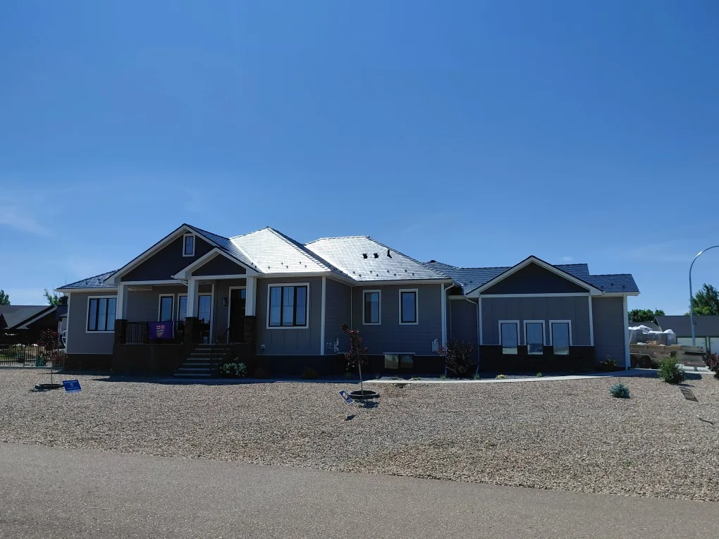 Deep Charcoal Interlock Slate aluminum roof on a single-storey home with a metal roof in a rural area, Dunmore, Alberta