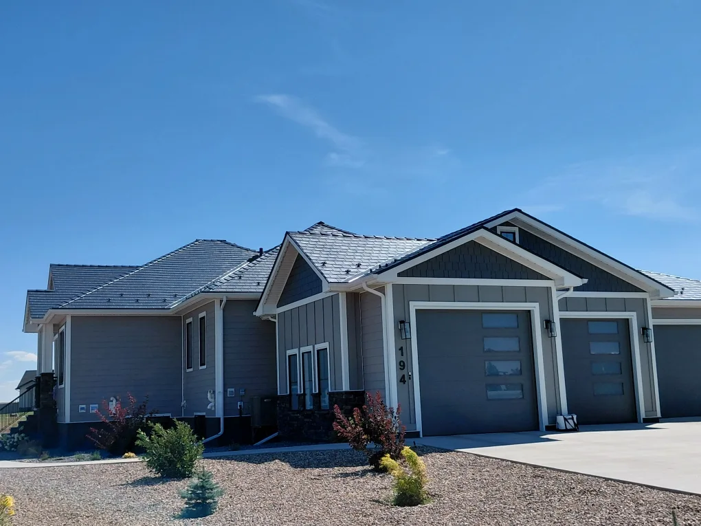 Deep Charcoal Interlock Slate aluminum roof on a grey ranch-style home with a metal roof in a rural area, Dunmore, Alberta