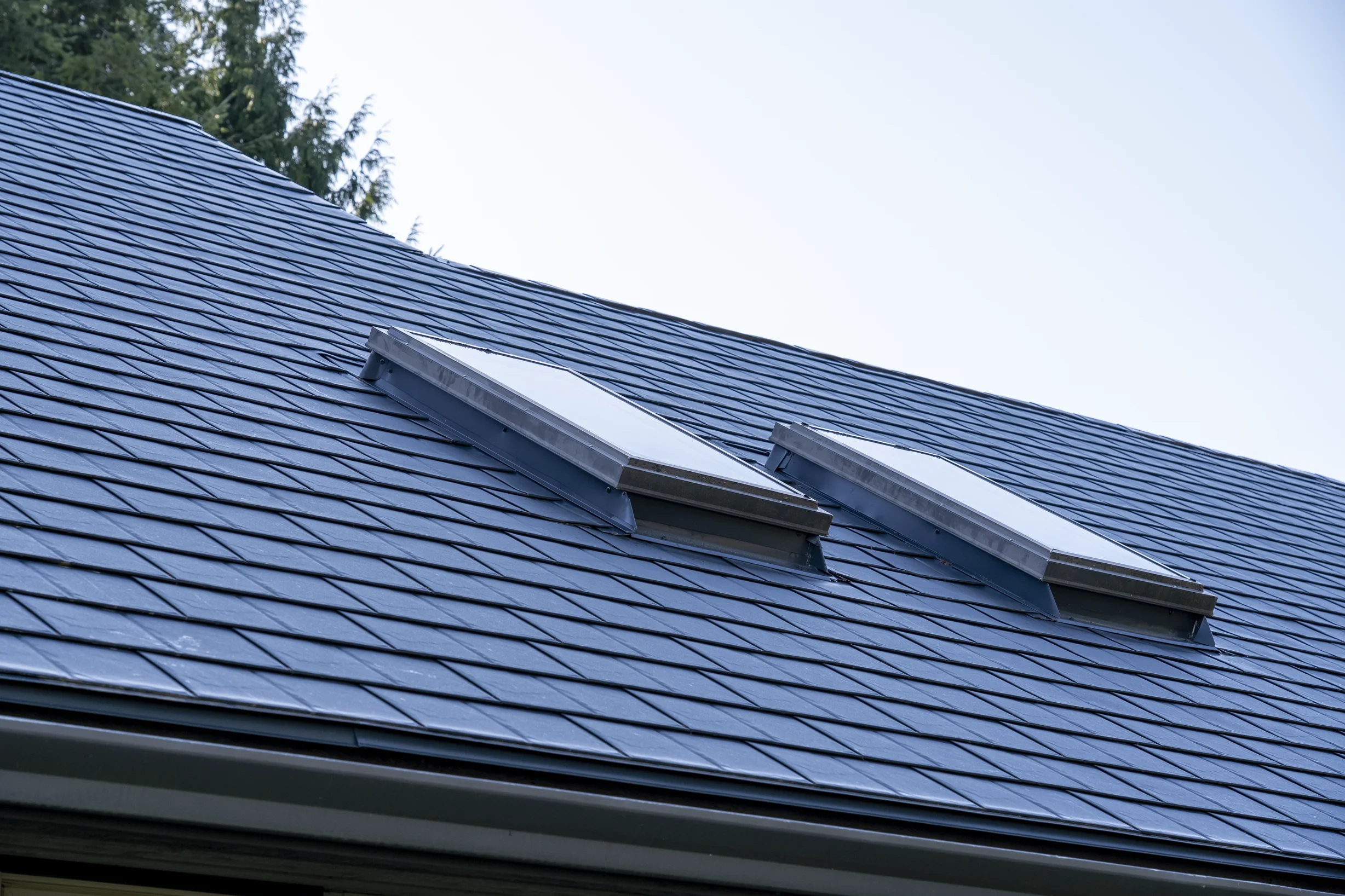Deep Charcoal Interlock Slate aluminum roof on a Deep Charcoal Interlock Slate metal roof on a house near, Sechelt, British Columbia