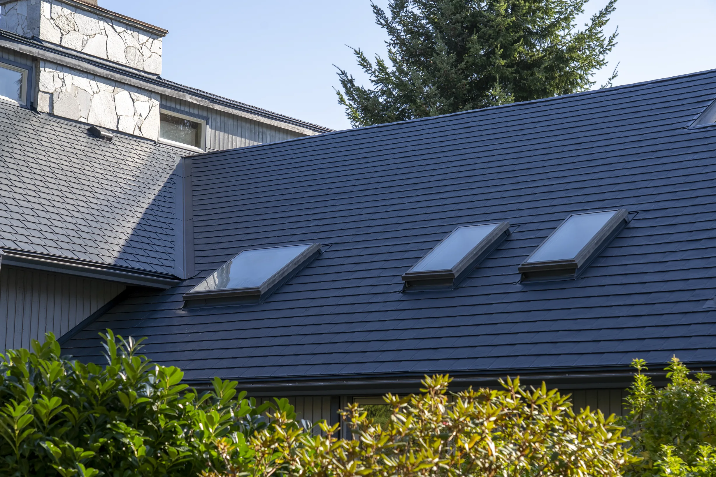 Deep Charcoal Interlock Slate aluminum roof on a single-family home with a deep charcoal metal roof in, Sechelt, British Columbia