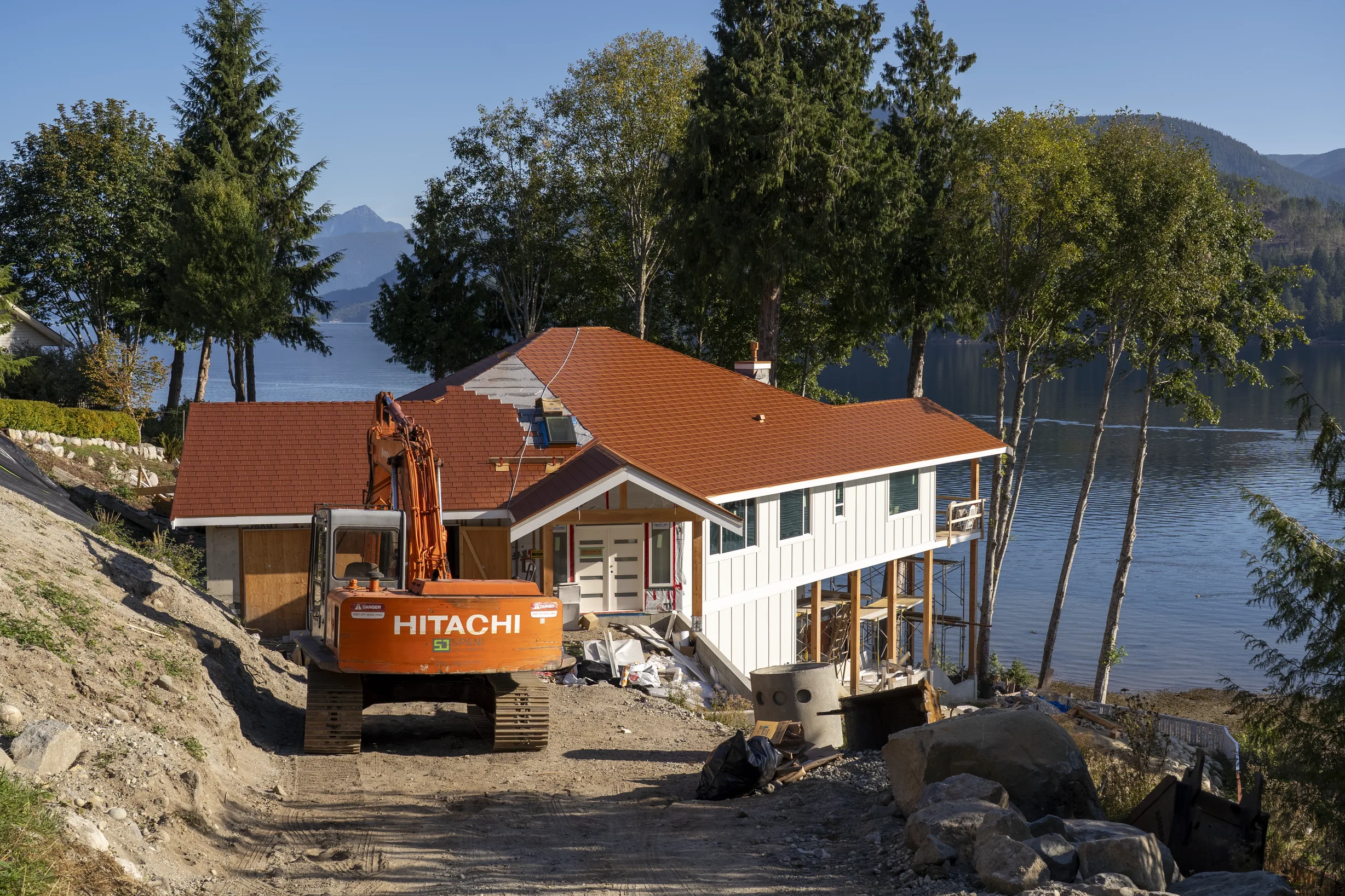 Copper Penny Interlock Slate aluminum roof being installed on the home, replacing new construction, Sechelt, British Columbia