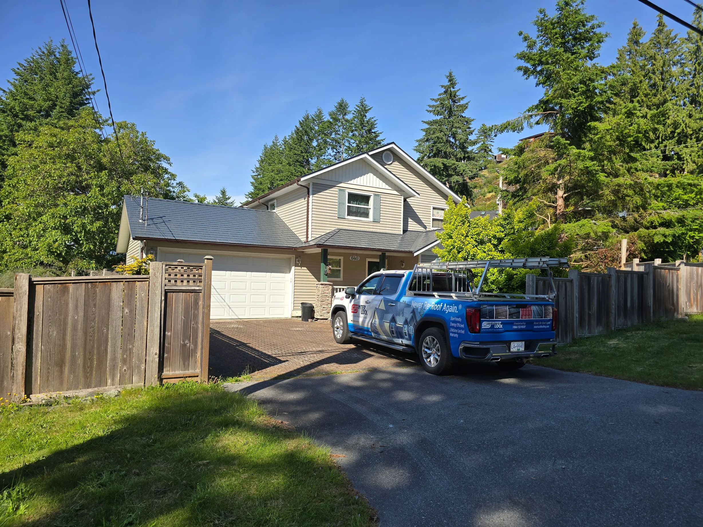 Deep Charcoal Interlock Slate aluminum roof on a home with a metal roof in a wooded area, Gibsons, British Columbia