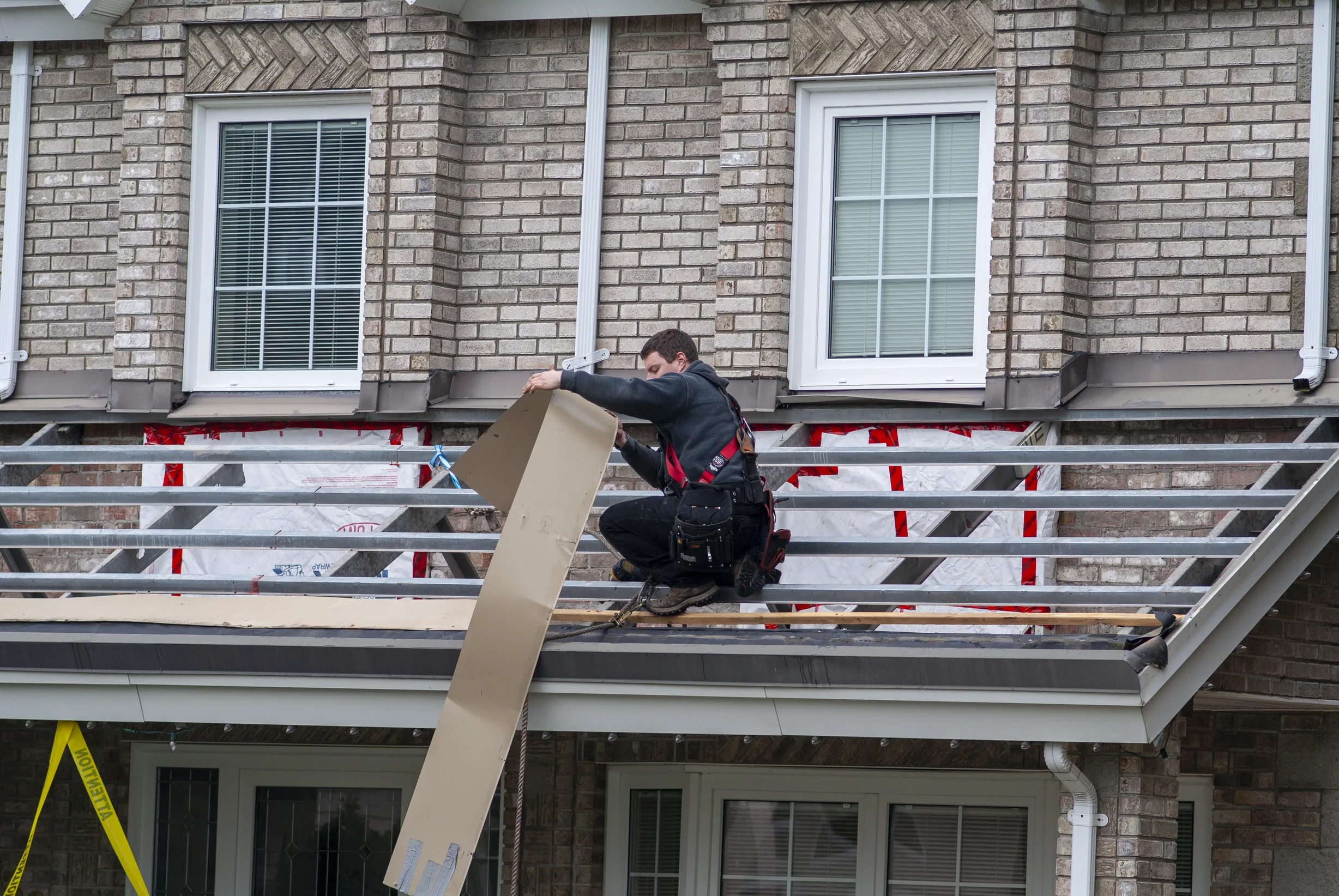 Black Interlock Slate aluminum roof being installed on the home, replacing a metal roof with broken tiles, Surrey, British Columbia