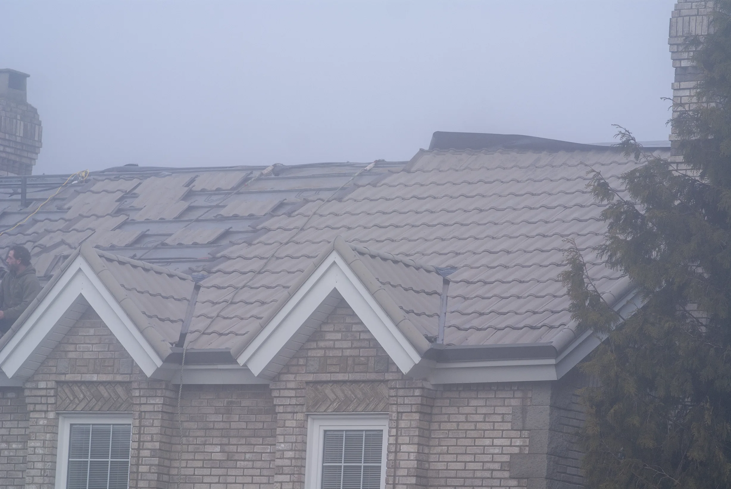 Black Interlock Slate aluminum roof being installed on the home, replacing a worn out metal roof, Surrey, British Columbia