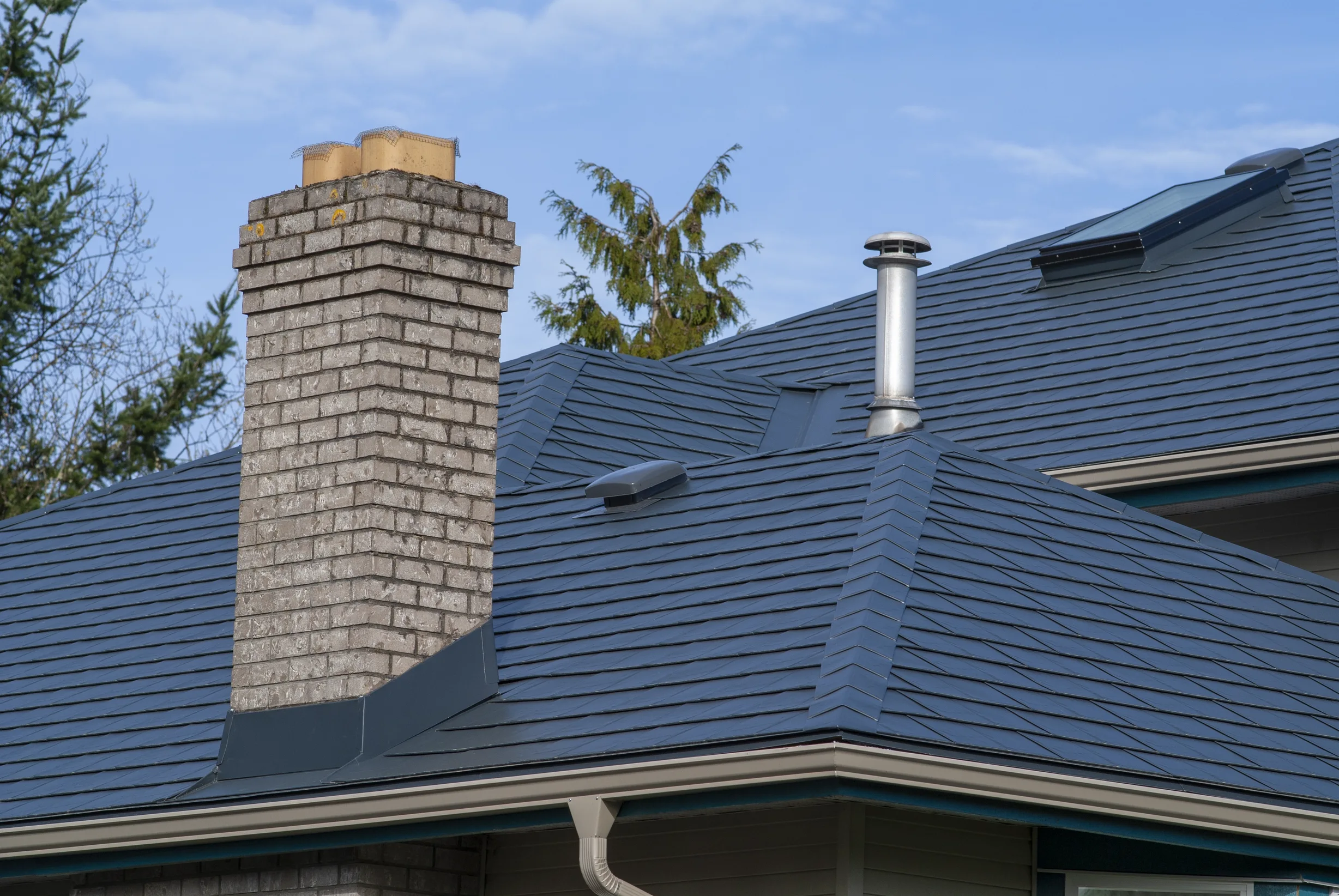 Deep Charcoal Interlock Slate aluminum roof on a deep charcoal metal roof on a single-family home in rural, Surrey, British Columbia