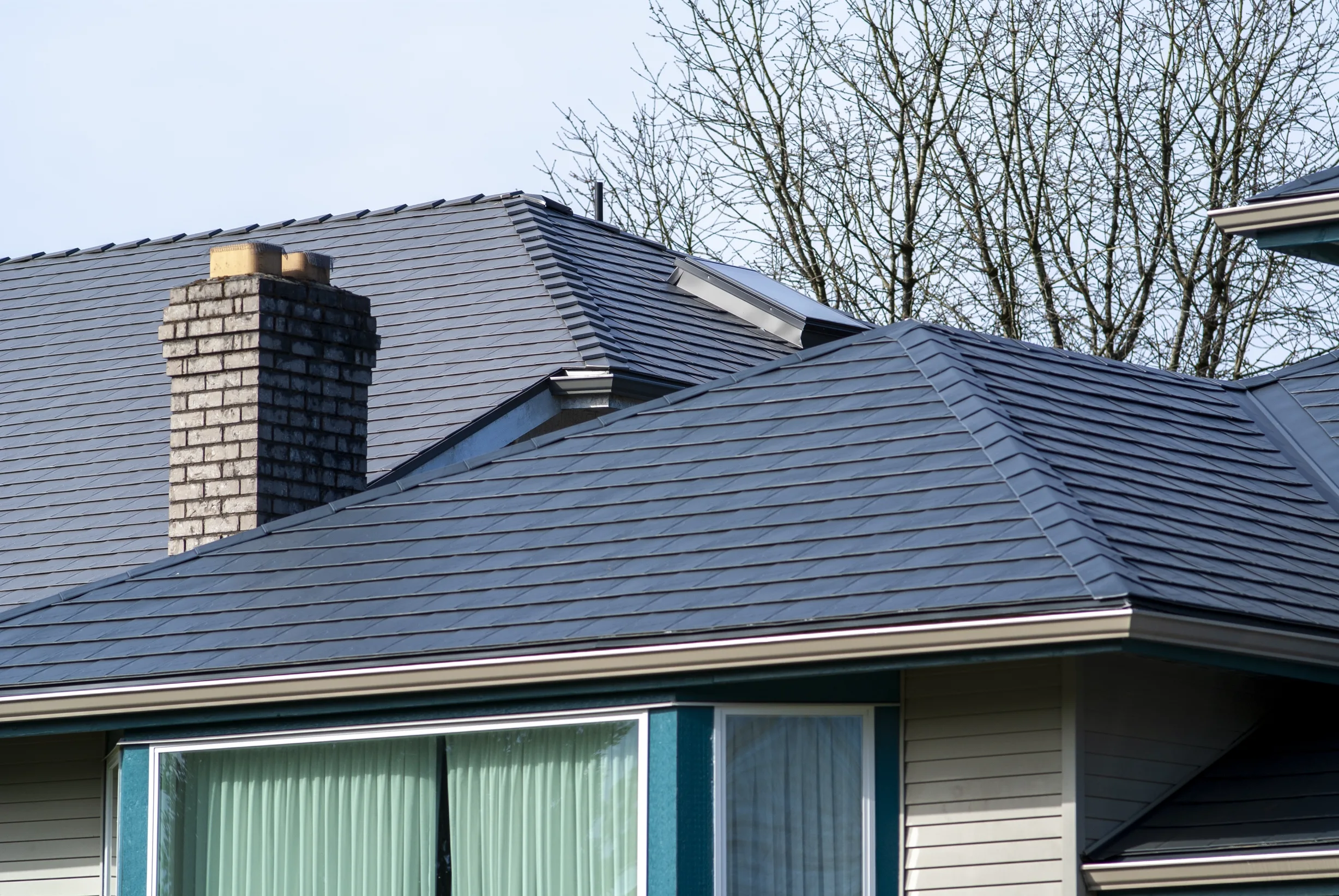 Deep Charcoal Interlock Slate aluminum roof on a modern home with a metal roof in Surrey, BC, Surrey, British Columbia