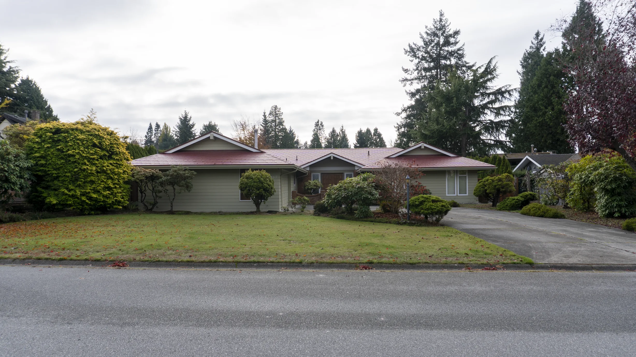 Tile Red Interlock Slate aluminum roof on a ranch style home with a tile red roof in a suburban, Delta, British Columbia