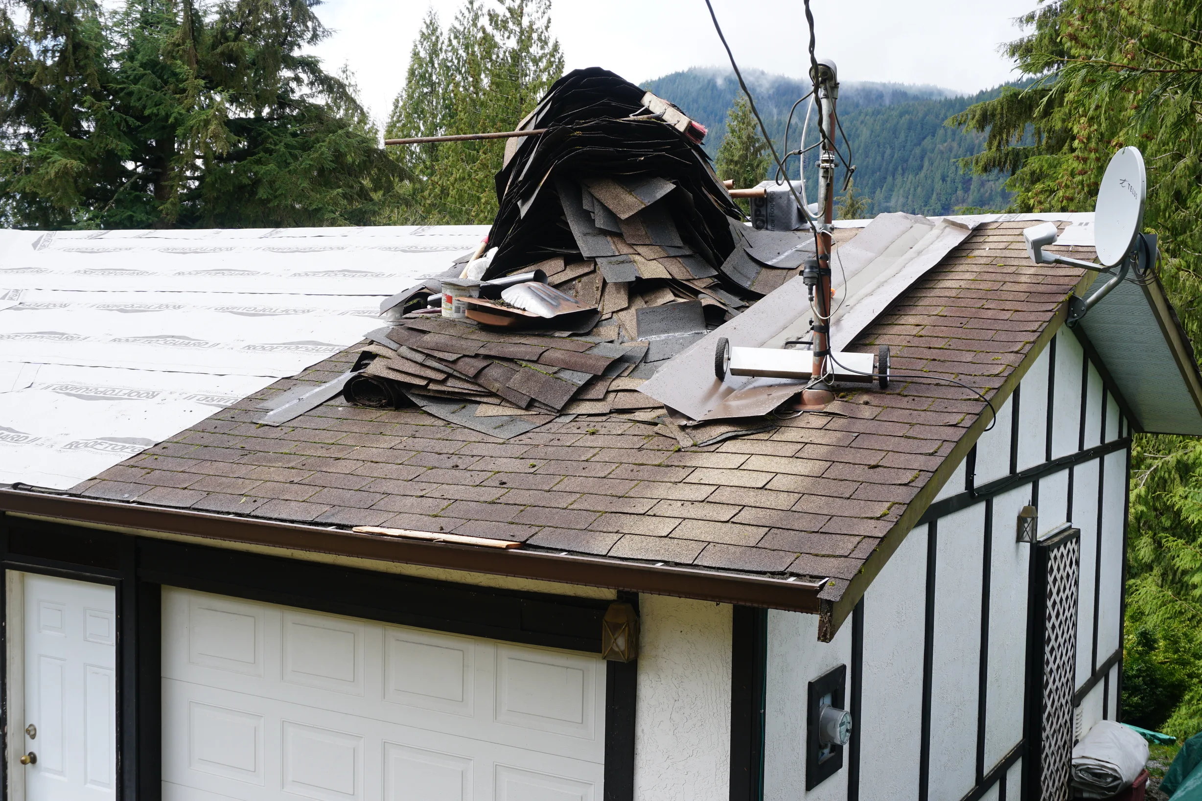 Deep Charcoal Interlock Slate aluminum roof being installed on the home, replacing a mossy asphalt shingle roof, Mission, British Columbia