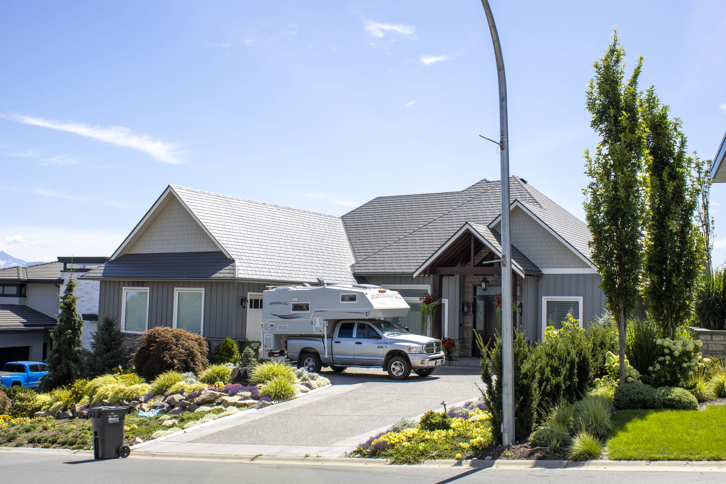Deep Charcoal Interlock Slate aluminum roof on a grey two-storey home with dormers in an urban setting, Abbotsford, British Columbia