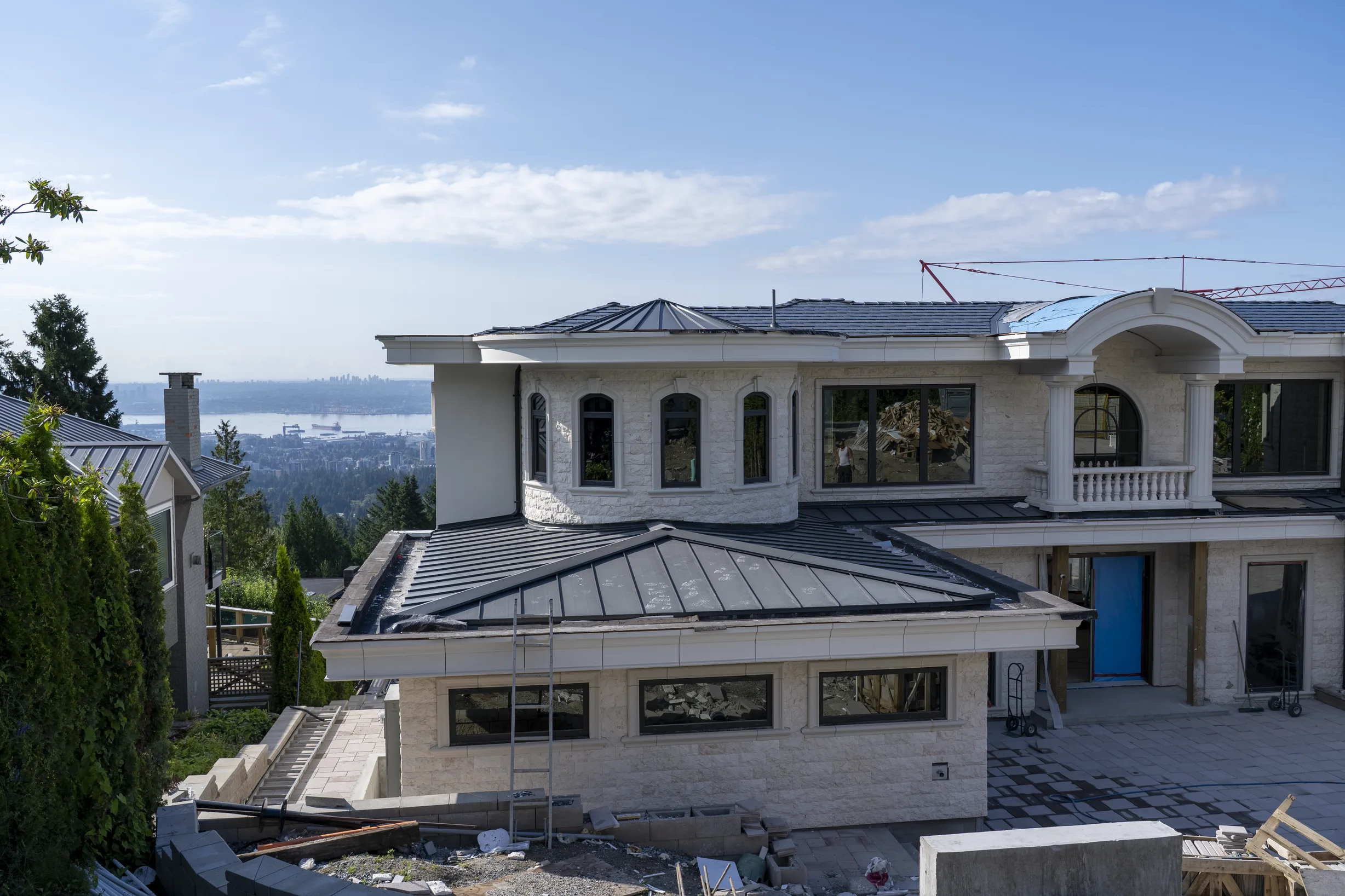Deep Charcoal Interlock Slate aluminum roof being installed on the home, replacing new construction, West Vancouver, British Columbia