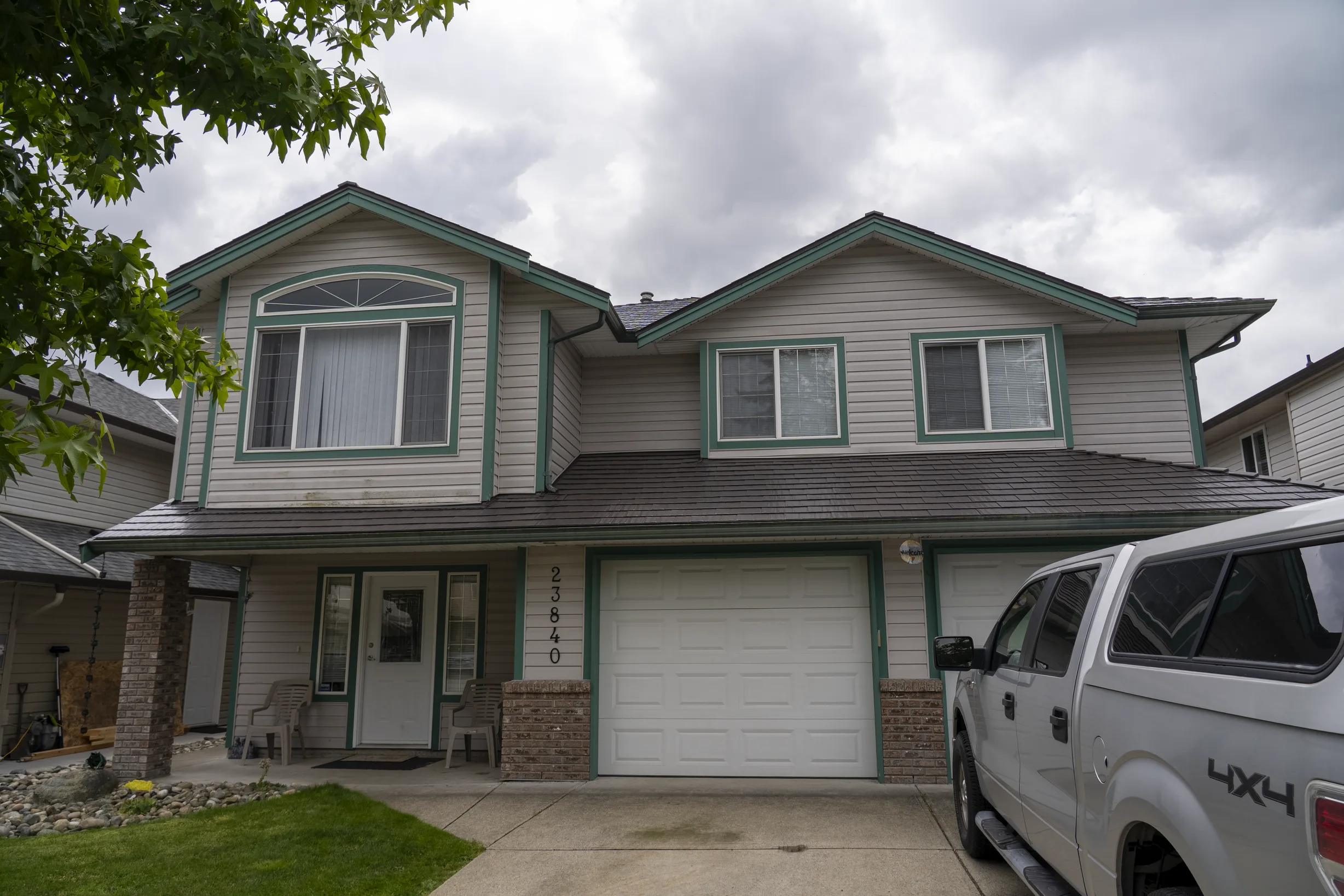 Tudor Brown Interlock Cedar Shingle aluminum roof on a Tudor style home with dormers in a rural suburban area, Maple Ridge, British Columbia