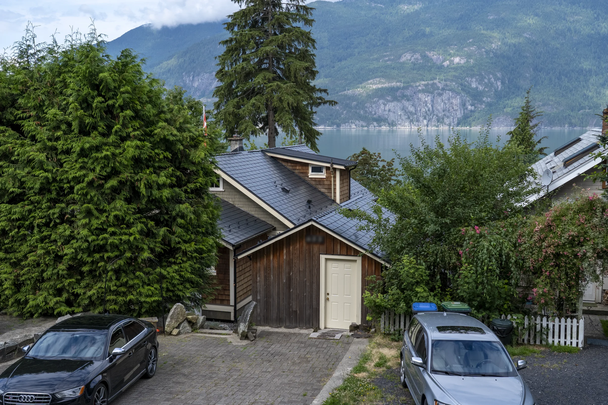 Black Interlock Slate aluminum roof on a brown single-family chalet with a metal roof in a, Britannia Beach, British Columbia
