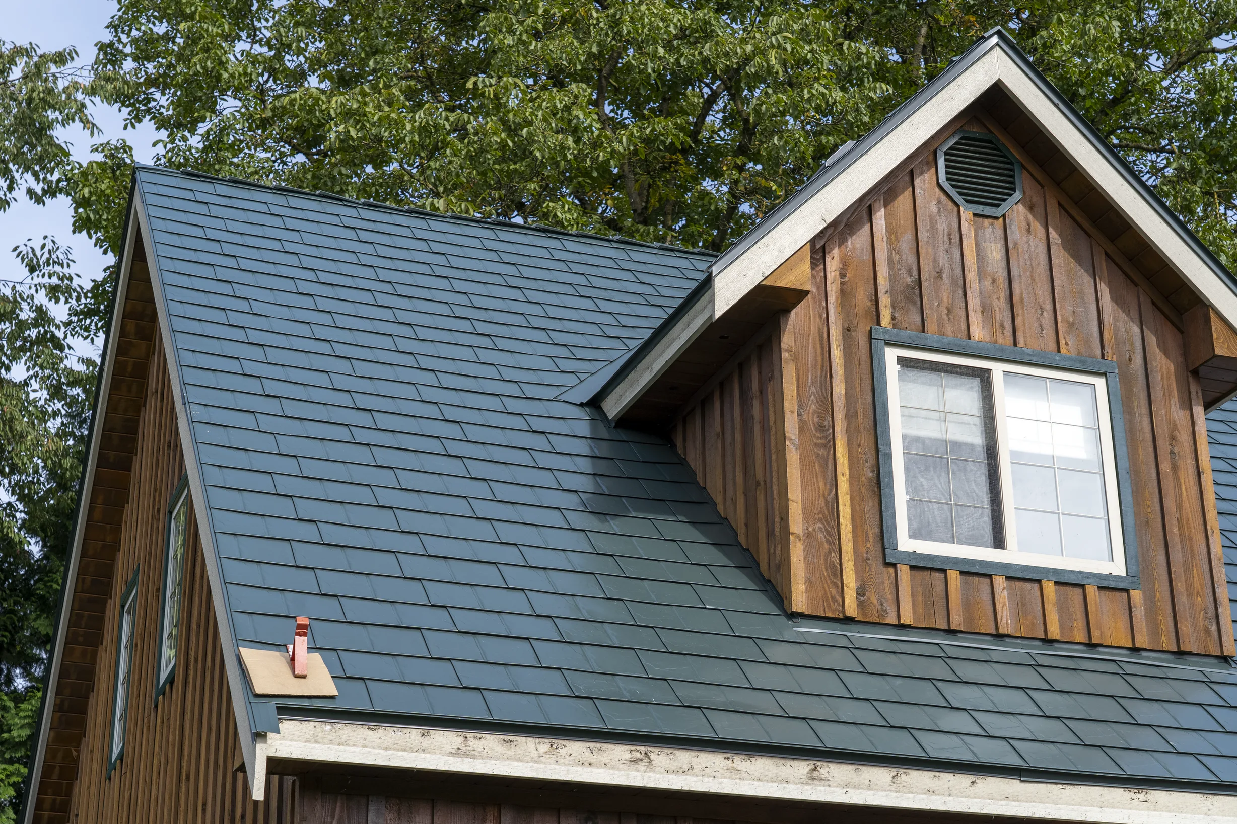 Hunter Green Interlock Slate aluminum roof on a two-storey wood house with a hunter green metal roof in a, Langley, British Columbia