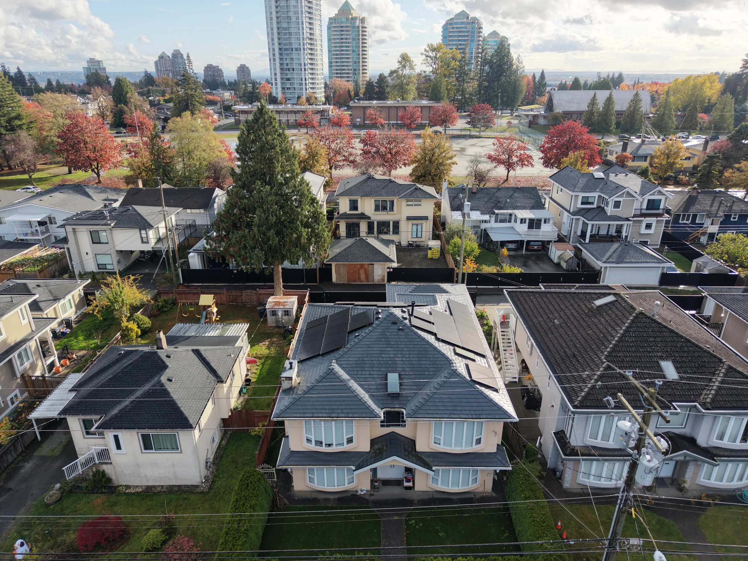 Deep Charcoal Interlock Slate aluminum roof on a two-storey home with a Deep Charcoal metal roof in a, Burnaby, British Columbia
