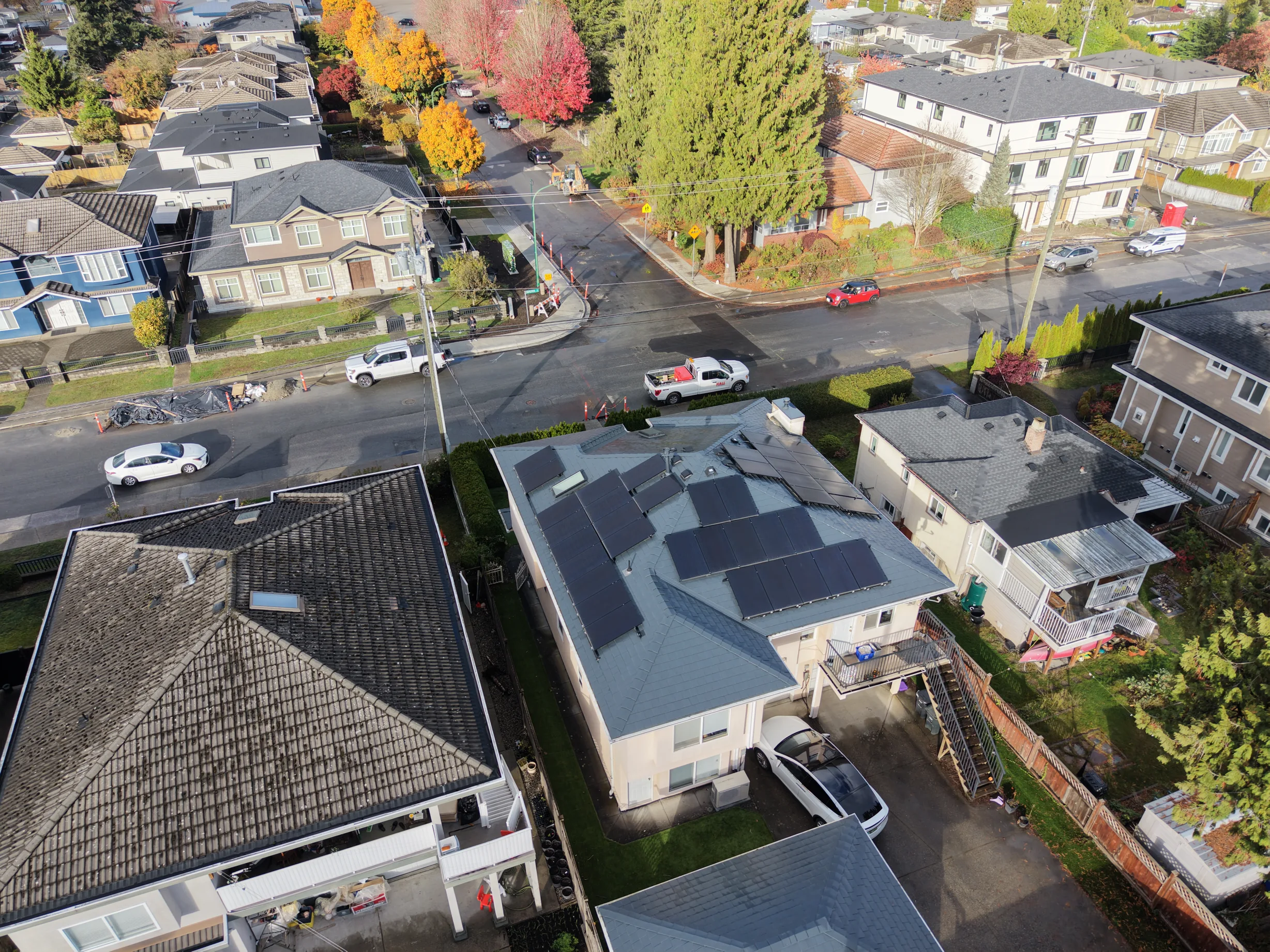 Deep Charcoal Interlock Slate aluminum roof on a white single-family home with a metal roof in a suburban, Burnaby, British Columbia