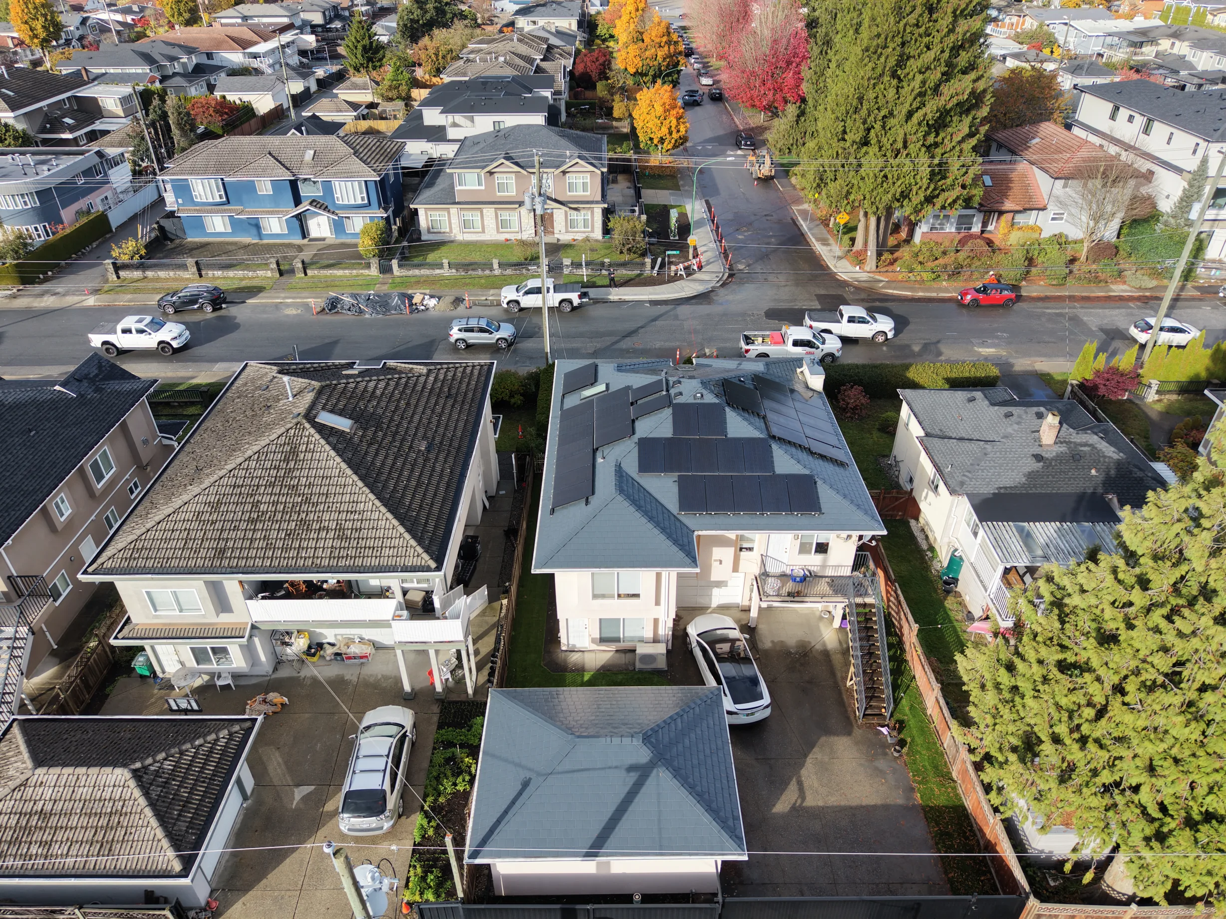 Deep Charcoal Interlock Slate aluminum roof on a white two-storey home with dormers in a residential, Burnaby, British Columbia