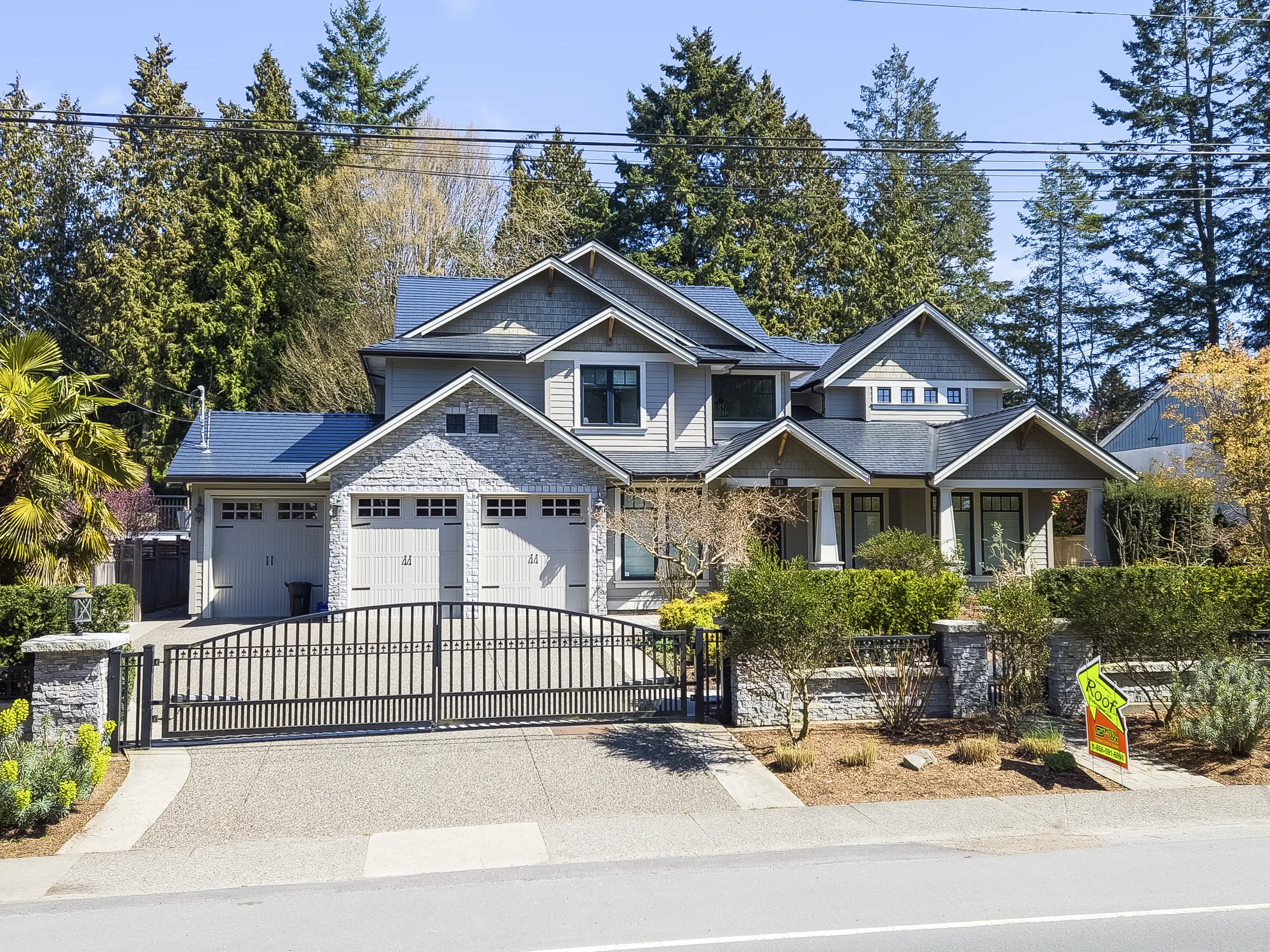 Black Interlock Cedar Shingle aluminum roof on a two-storey modern home with dormers in a forested, Delta, British Columbia