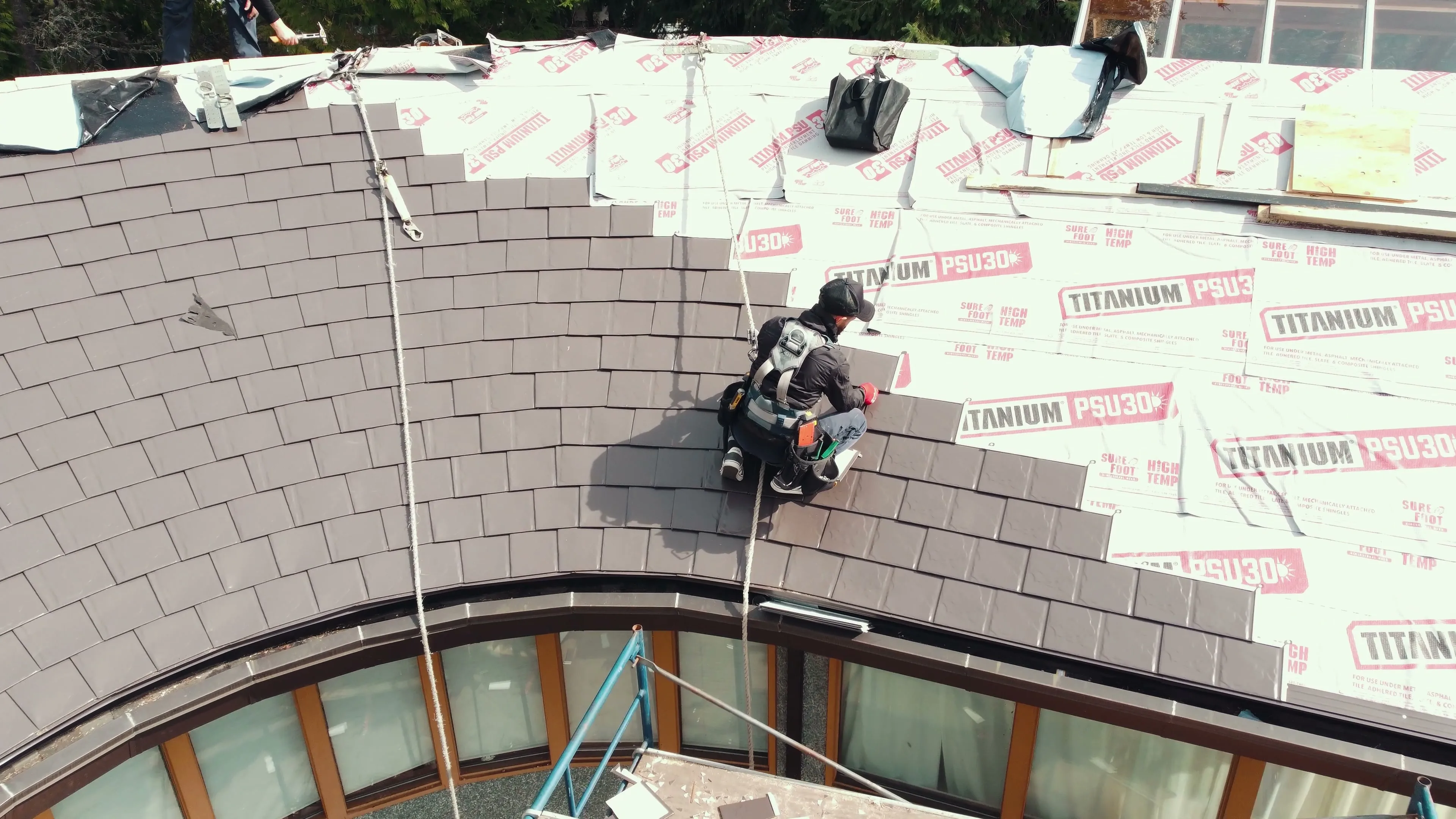 Interlock aluminum Tudor Brown slate metal roof installed on a West Vancouver, BC home, replacing a 30-year-old cedar shake roof.