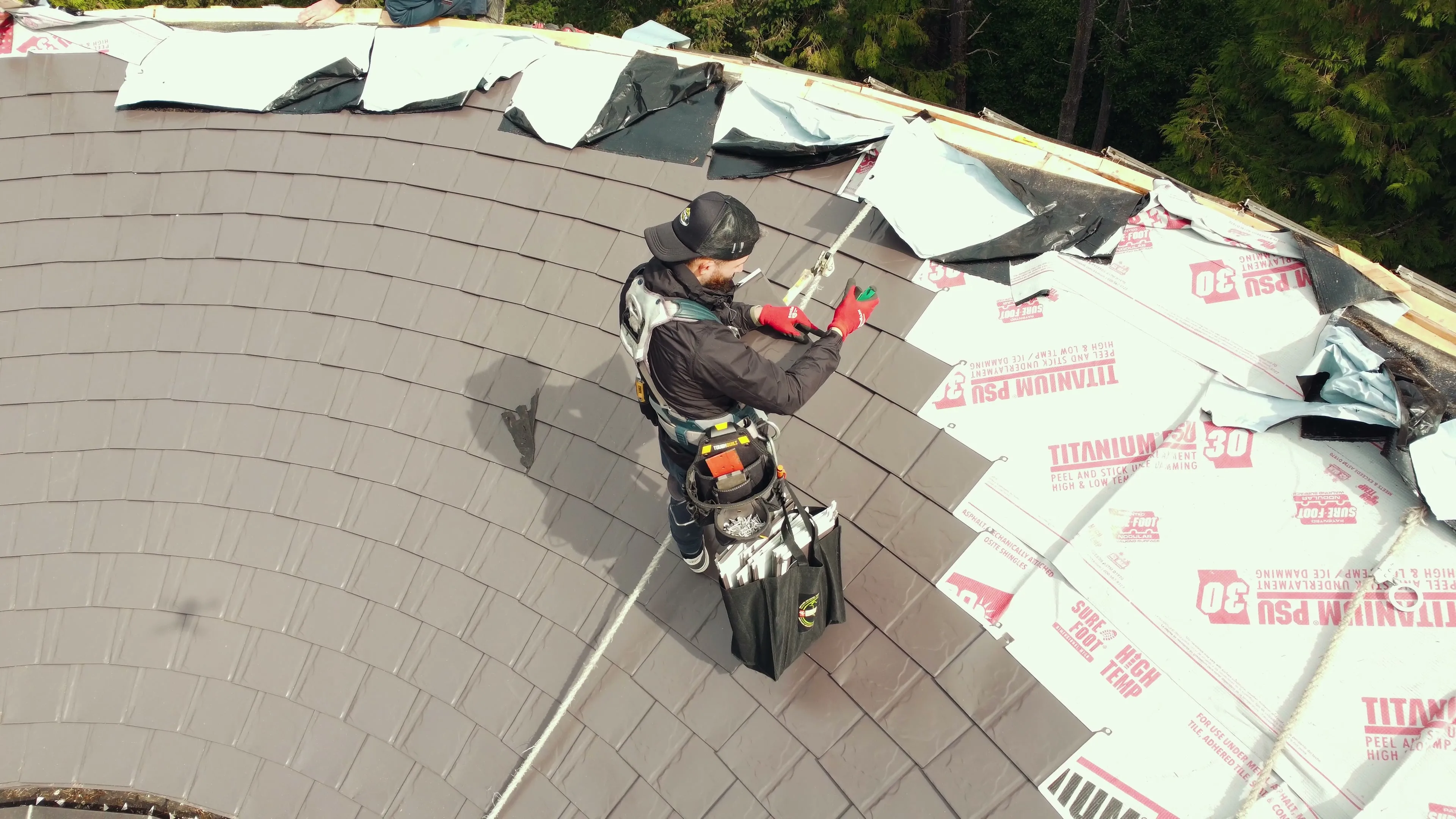 Finished Interlock aluminum Tudor Brown slate metal roof on a West Vancouver, BC home, replacing an aging cedar shake roof.