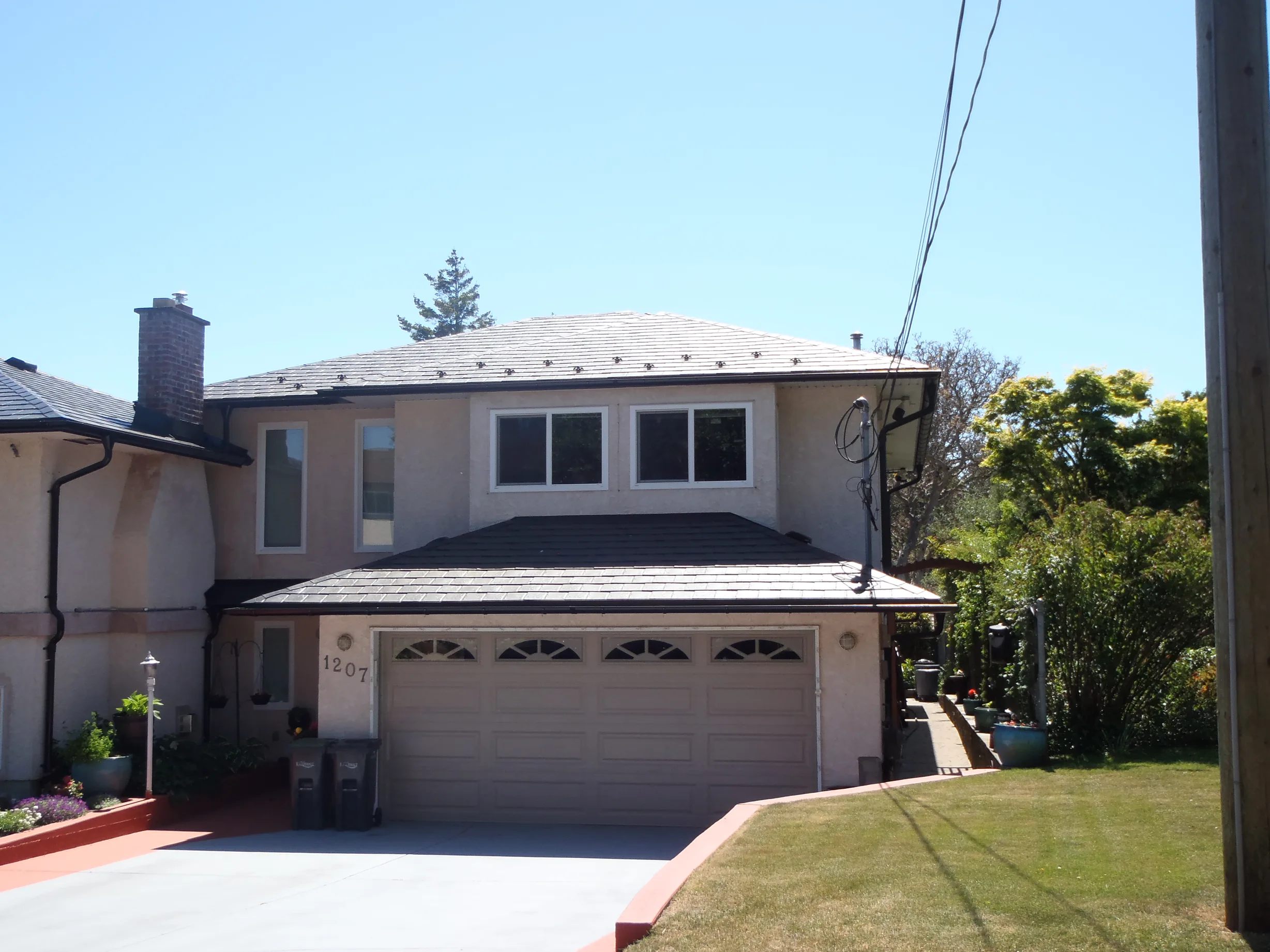 Black Interlock Slate aluminum roof on a two-storey home with a black metal roof in Victoria, BC, Victoria, British Columbia