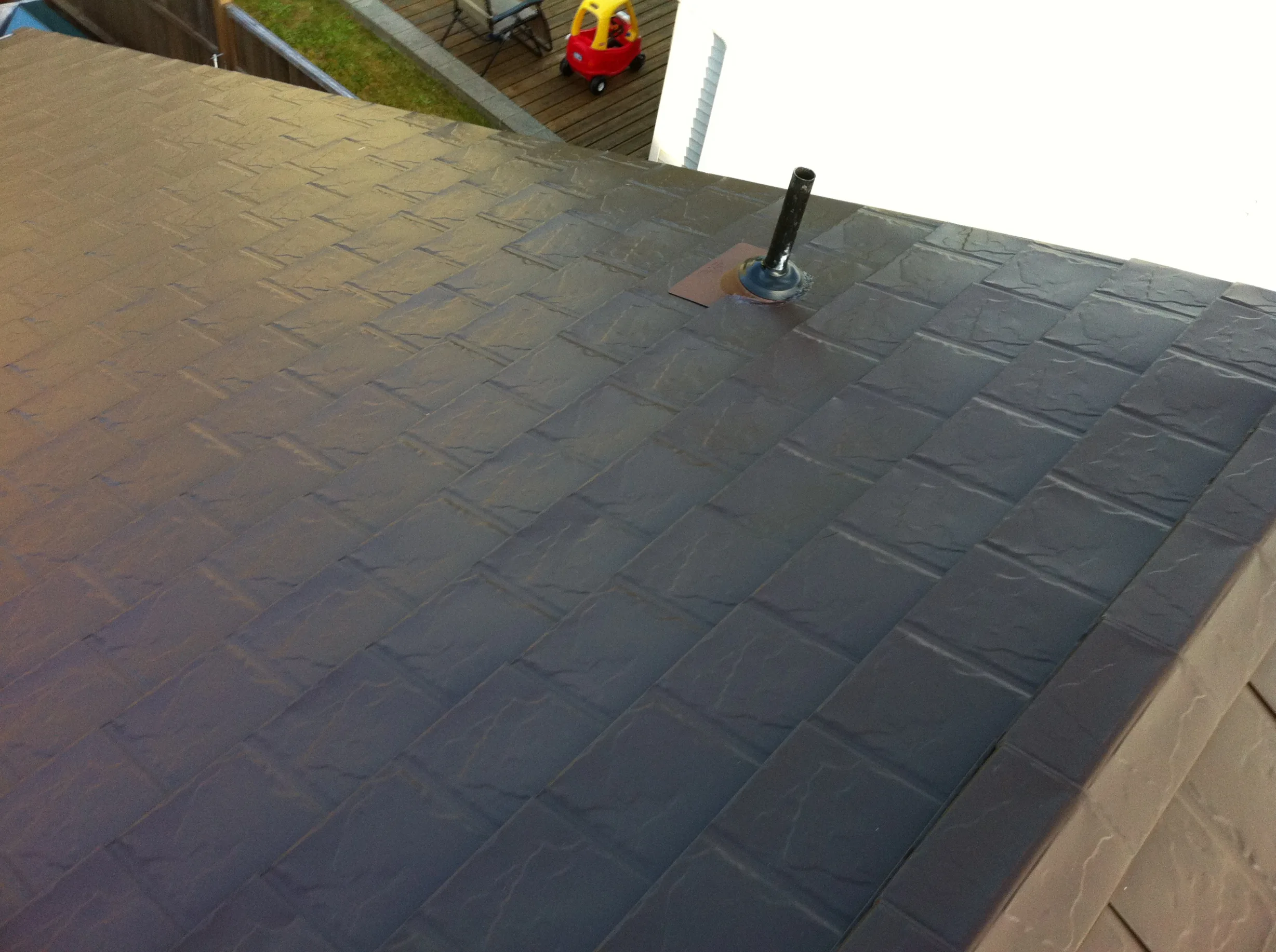 Colonial Brown Interlock Slate aluminum roof on a Colonial Brown metal roof on a two-storey home in a, Campbell River, British Columbia