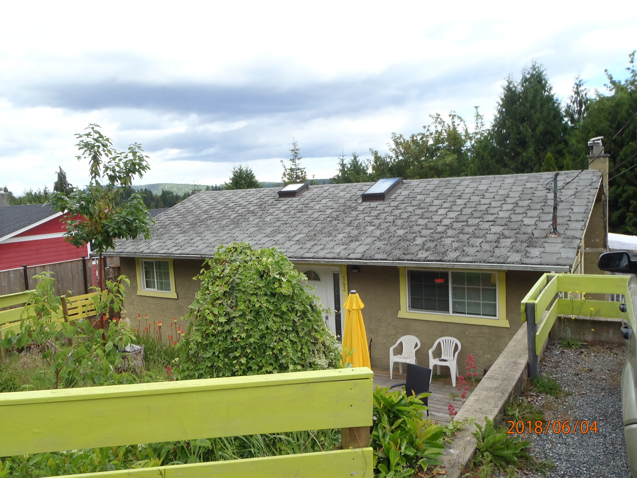 Before: a leaking asphalt shingle roof on the home, Ladysmith, British Columbia, ahead of a Deep Charcoal Interlock Slate aluminum roof