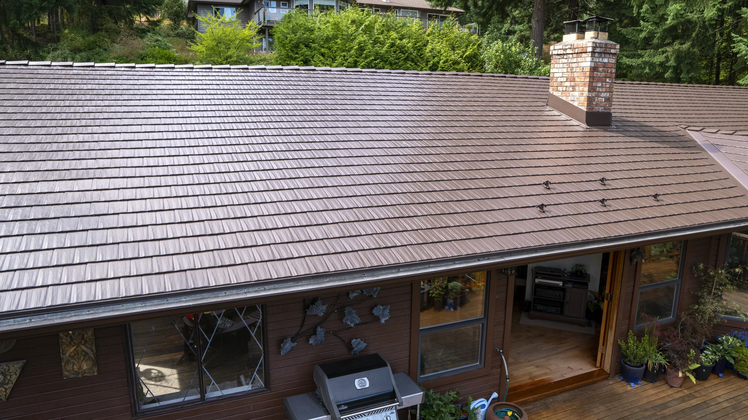 Colonial Brown Interlock Cedar Shingle aluminum roof on a brown one-storey home with a colonial style and a metal, Salt Spring Island, British Columbia