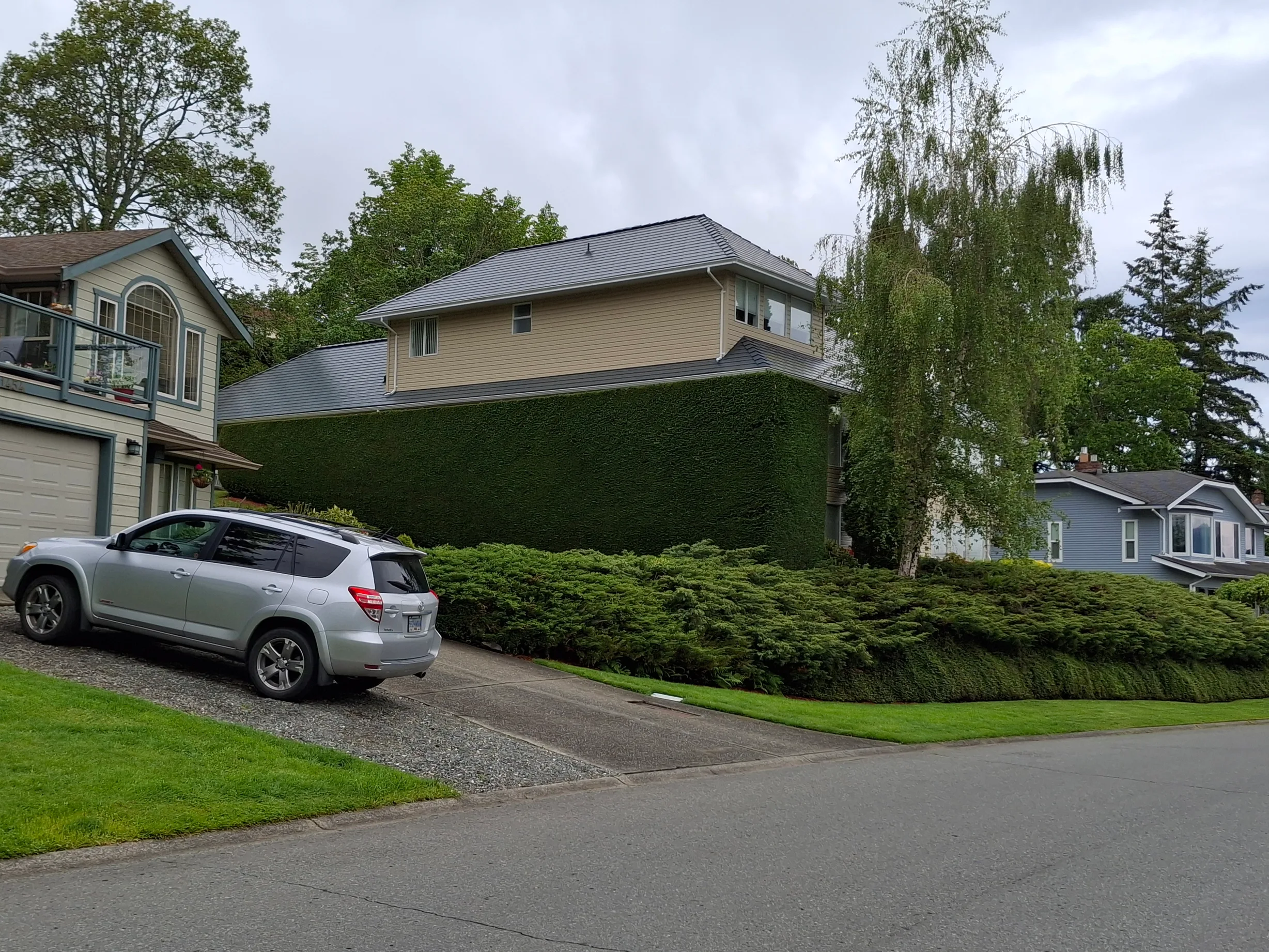 Deep Charcoal Interlock Slate aluminum roof on a single-family home with a metal roof in a suburban area, Duncan, British Columbia